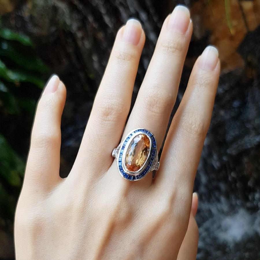 Imperial Topaz 8.01 carats with Blue Sapphire 1.29 carats and Diamond 0.19 carat Ring set in 18 Karat White Gold Settings 

Width:  1.5 cm 
Length: 2.3 cm
Ring Size: 53
Total Weight: 9.77 grams

