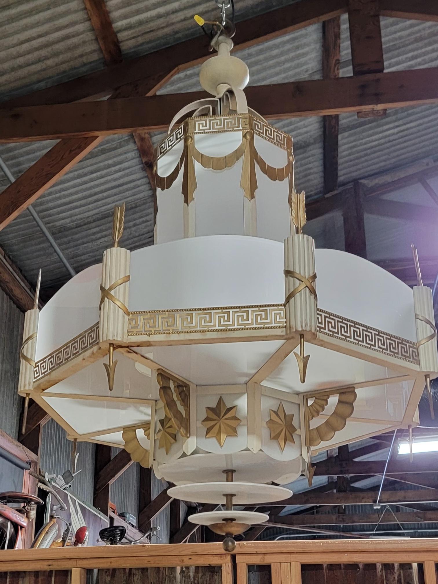 Exceptional and historic Art Deco theater chandeliers Created for the Encore Theater in Burlingame, California, opening in 1930. Original painted surface in off white and gold. Removable milk glass panels. Color of chandelier can be changed to