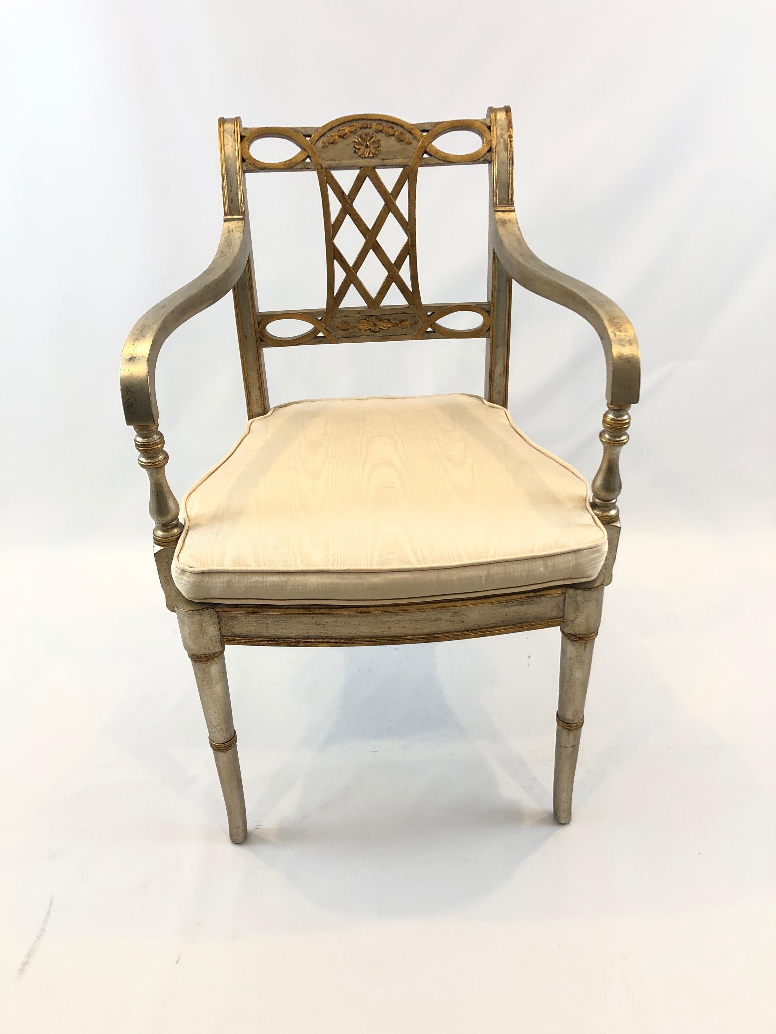 A very glamorous elegant armchair having silver and gold carved wood and caned seat, with a custom silk cream seat cushion and lovely floret and foliage decoration.
Measures: Seat height without cushion 17.5, with cushion 19.75
Arm height