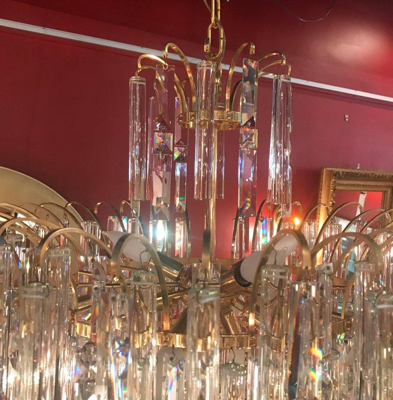 A breathtaking shimmering multi tiered crystal and gold chandelier with Swarovski crystals.  There are 4 tiers of crystals, two shapes of crystals;  diamond shaped are 7