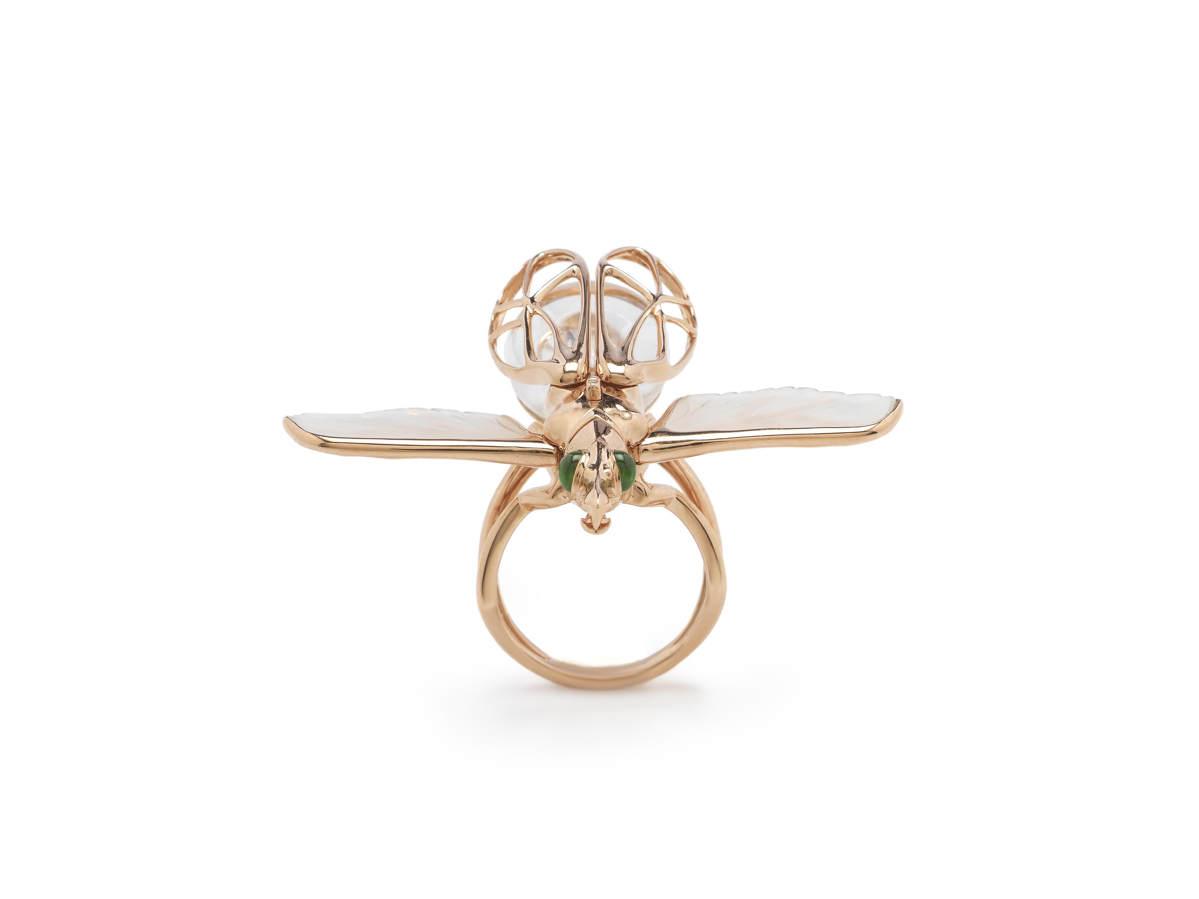 This stunning cocktail ring’s ingenious construction makes it a true conversation piece. Designed in 18k rose gold, the beetle-like insect’s upper wings, set with green tsavorites, can be opened or closed to reveal the insect’s rock crystal body