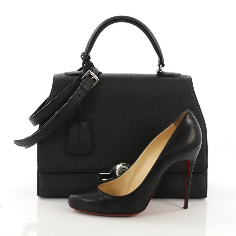 This Moynat Rejane Top Handle Bag Leather Medium, crafted in black leather, features a leather top handle, adjustable shoulder strap, and silver-tone hardware. Its clasp closure opens to a beige leather interior with zip pocket. **Note: Shoe