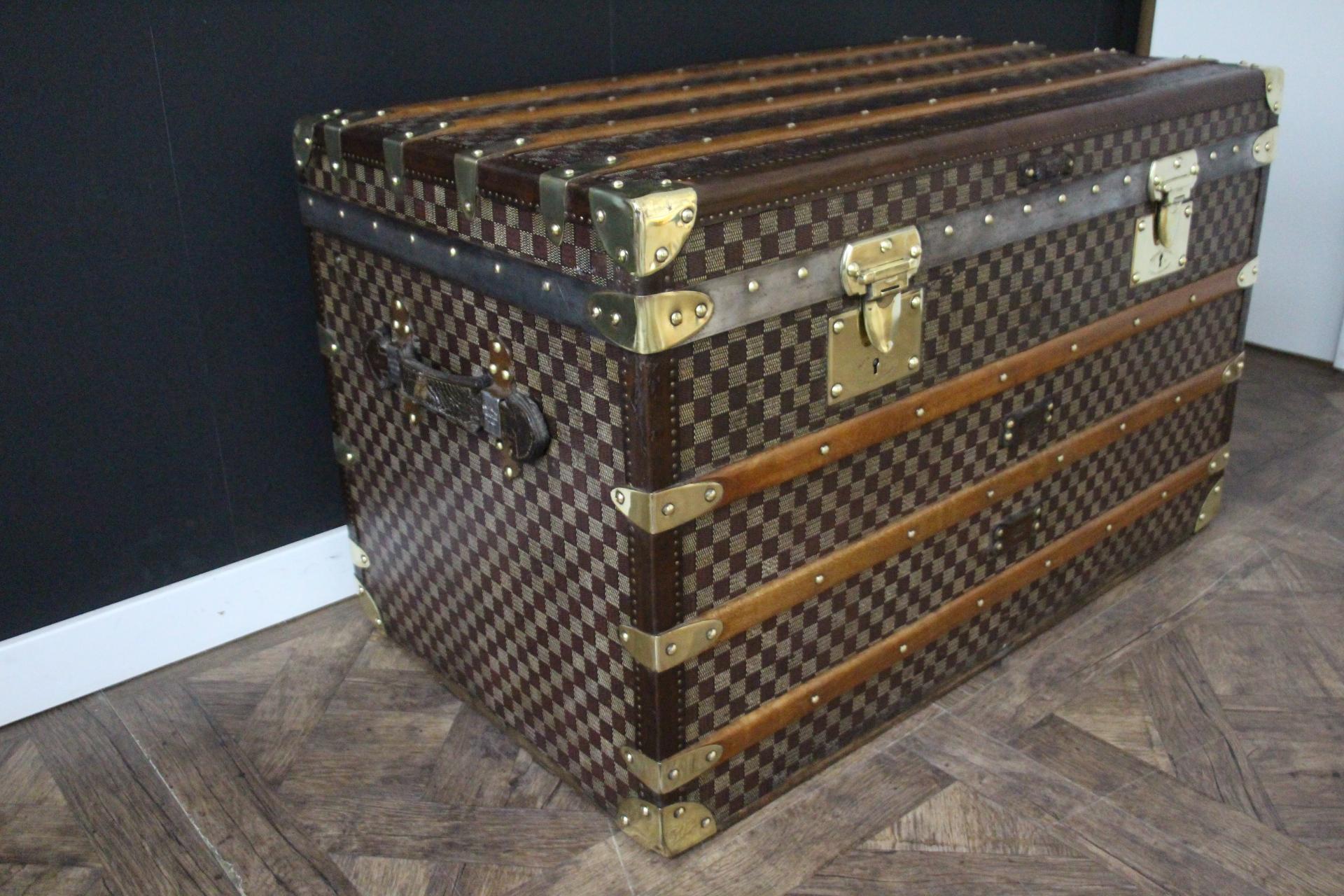 This beautiful and very rare Moynat trunk features beautiful checkers canvas, chocolate color leather trim, large leather side handles with stamped Moynat flanges and 2 solid brass stamped Moynat locks . Its patina is magnificent. Moreover it has a