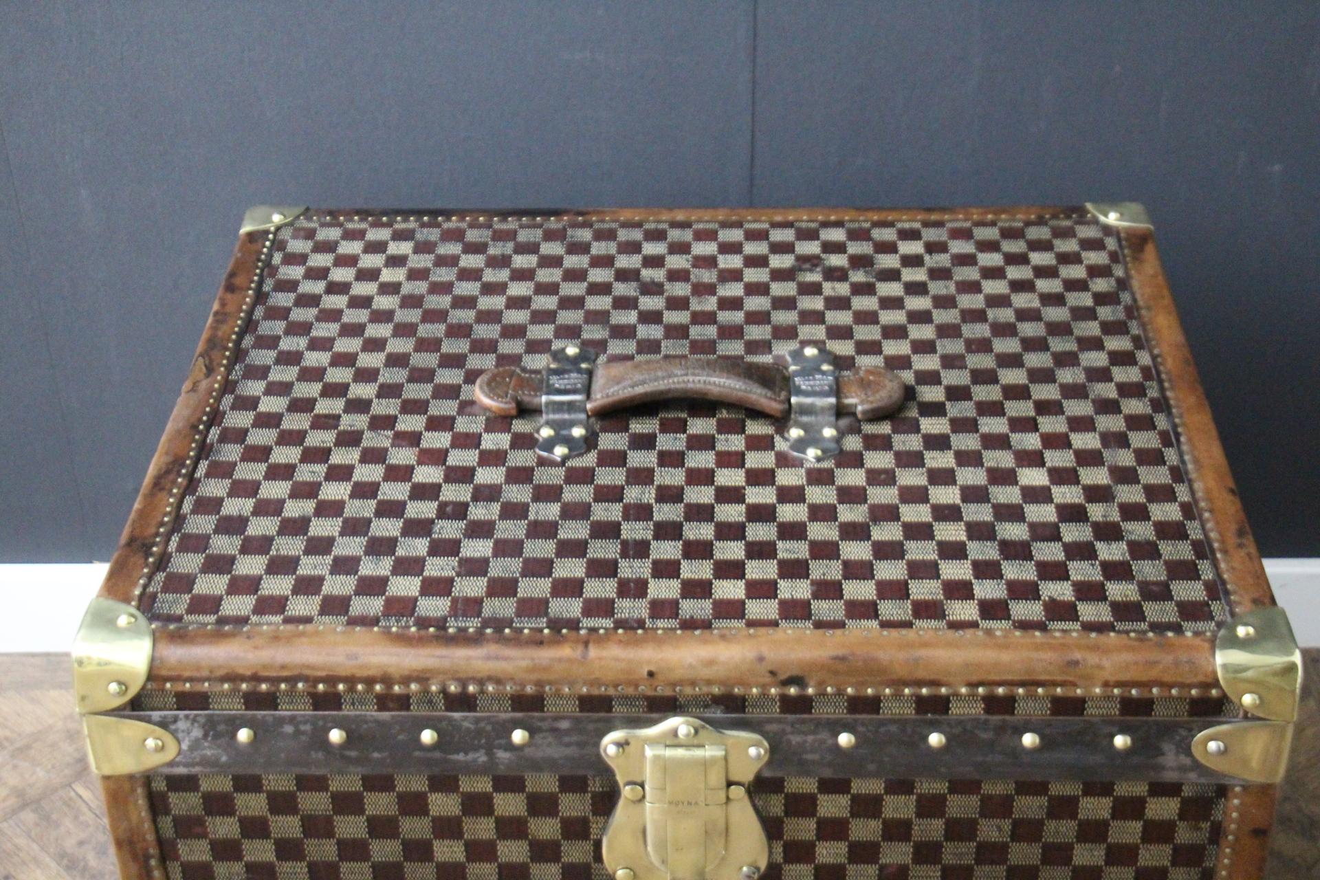 This beautiful and very rare Moynat trunk features beautiful checkers canvas, chocolate color leather trim, large leather top handle with stamped Moynat flanges and solid brass stamped Moynat lock. Its patina is magnificent. Moreover it has a very