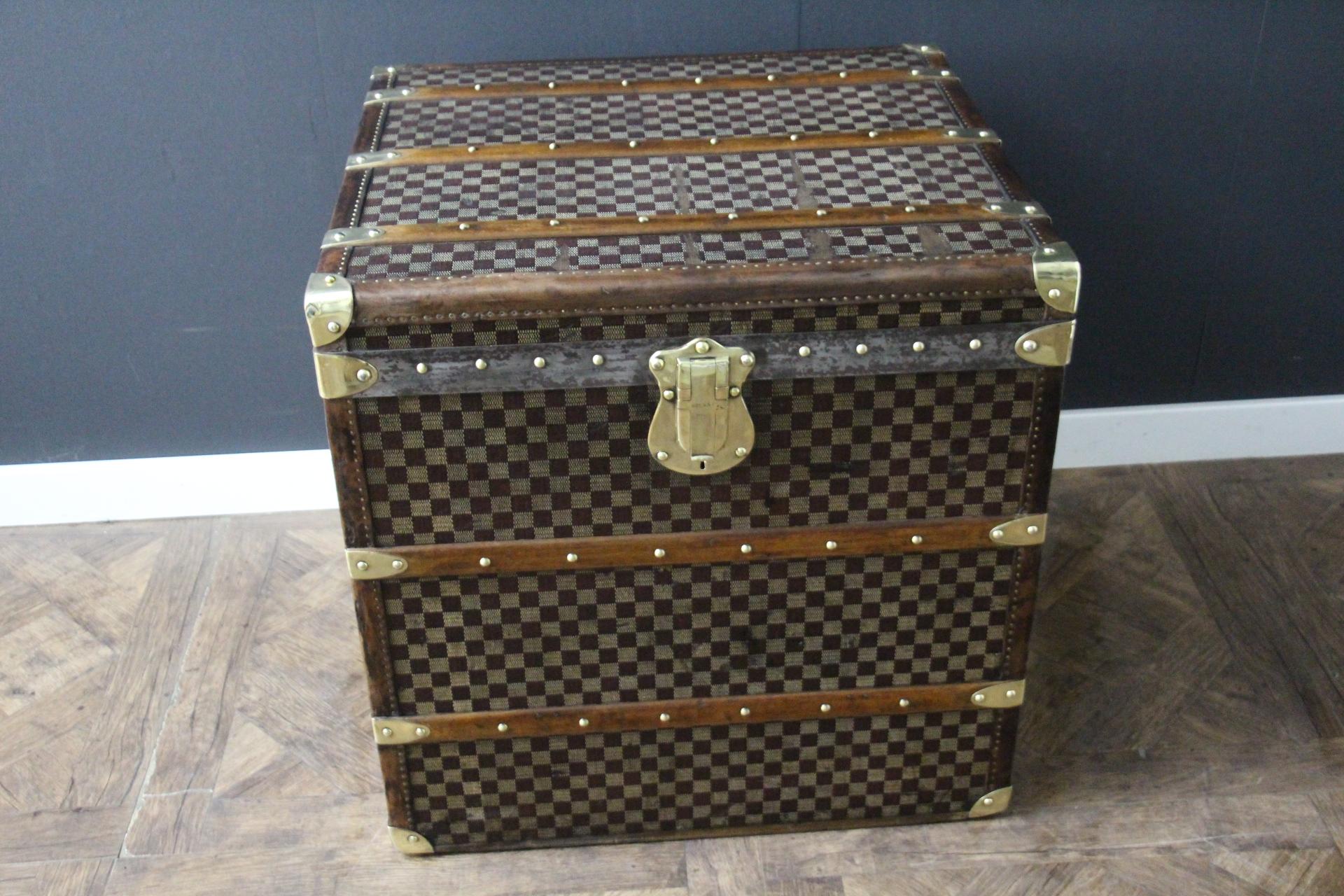 This beautiful and very rare Moynat trunk features beautiful checkers canvas, chocolate color leather trim, large leather side handles with stamped Moynat flanges and solid brass stamped Moynat lock. Its patina is magnificent. Moreover it has a very