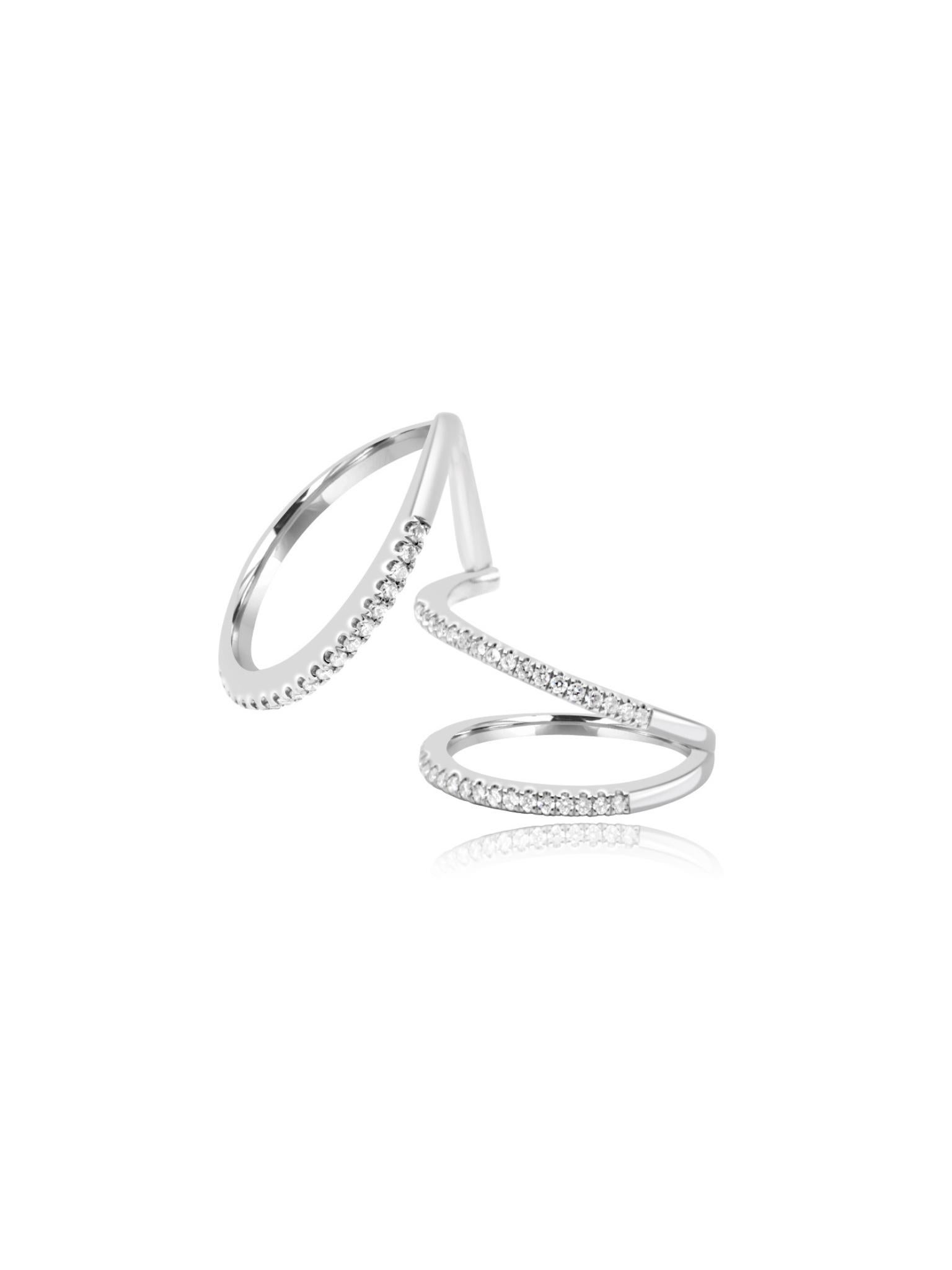 Beautifully crafted from 18 karat white gold, this spiral ring features a middle bend mechanism for comfortable wear. The front of the ring is adorned with stunning round cut diamonds, adding a touch of elegance to its unique design.

