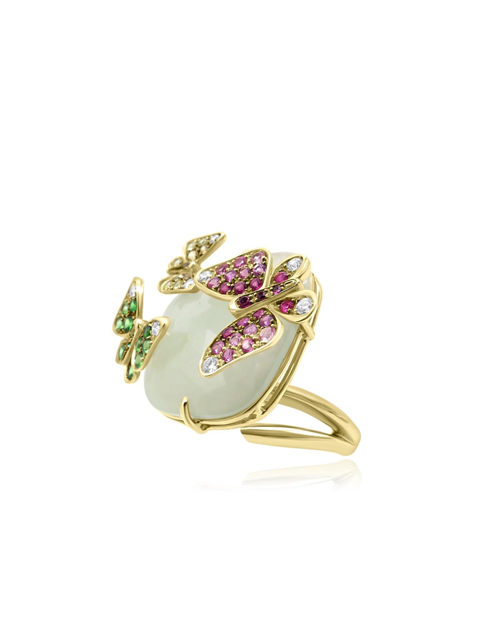 This is an elegant 18-karat gold ring adorned with a variety of gemstones, including colorful sapphires, tsavorites, and round-cut diamonds, all designed in the form of delicate butterflies surrounding a central quartz gemstone. The intricate