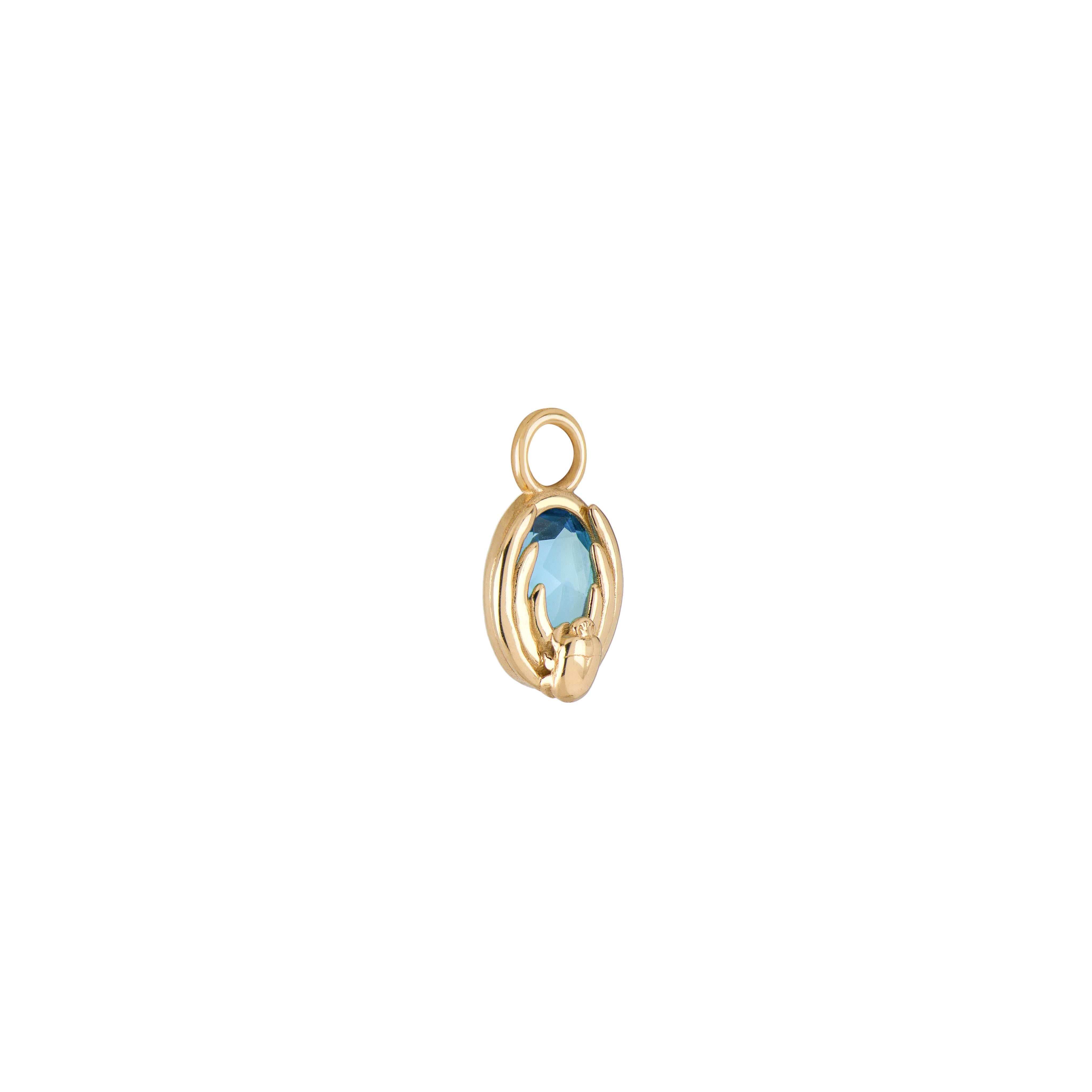 A collaboration between Mozafarian and Katarina Tarazi, the Cancer Capsule Pendant embodies the ancient zodiac, which was once represented by a scarab before becoming a crab.

This refined piece features a Swiss blue topaz, set in 18k yellow gold,