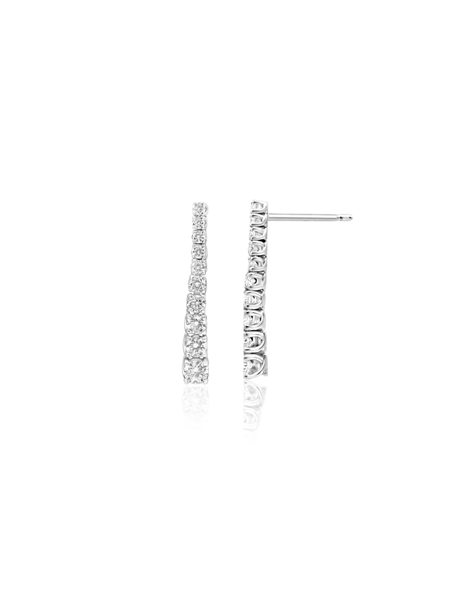 These beautiful Mozafarian 18 karat white gold small drop diamond earrings feature a design with diamonds that gradually increase in size toward the bottom. The arrangement mimics a sparkling drop, creating a graceful and elegant look. 