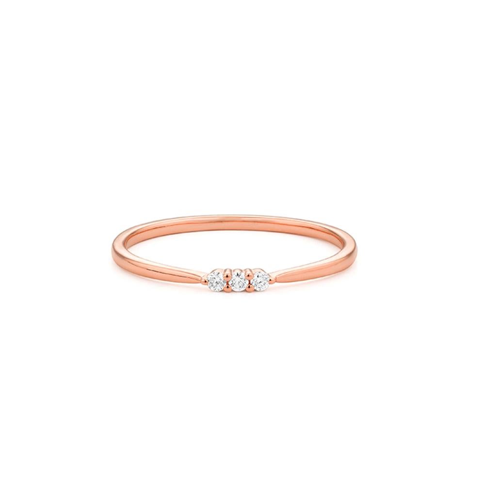 Délicate et minimale, cette bague est réalisée en or rose 18ct et présente trois diamants taille brillant sertis dans un anneau fin et poli. Subtile mais pleine de charme, sa simplicité la rend parfaite pour l'empiler, l'offrir ou la porter comme