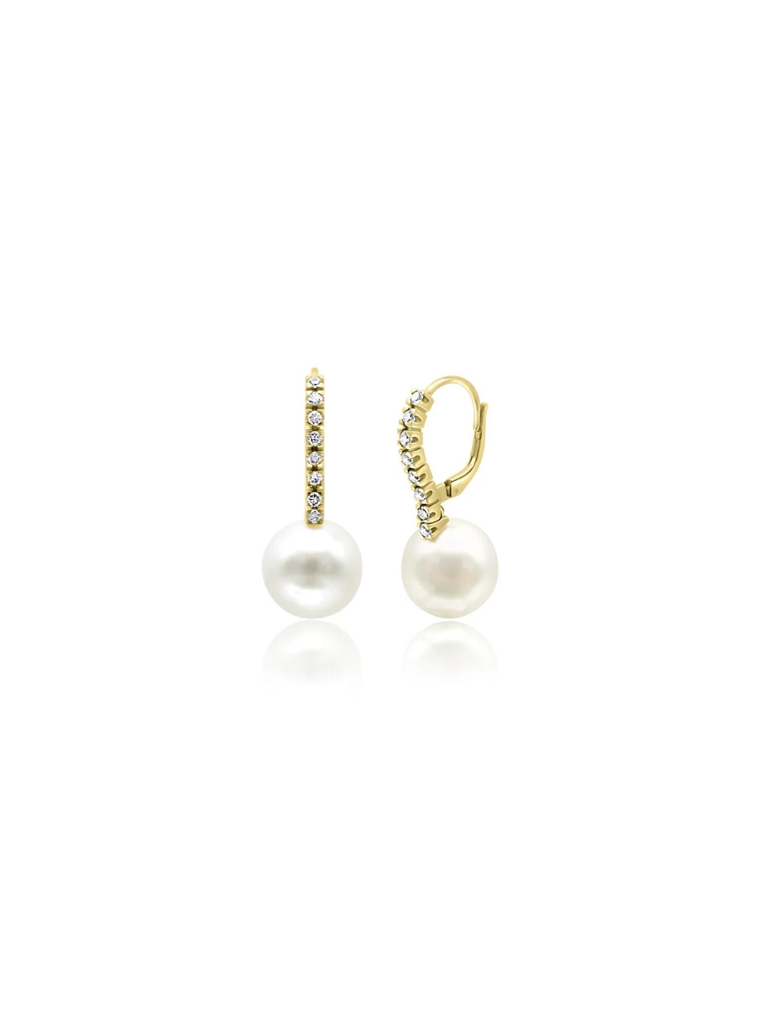 18 karat yellow gold earrings featuring lustrous white pearls, elegantly adorned with small diamonds along the front.