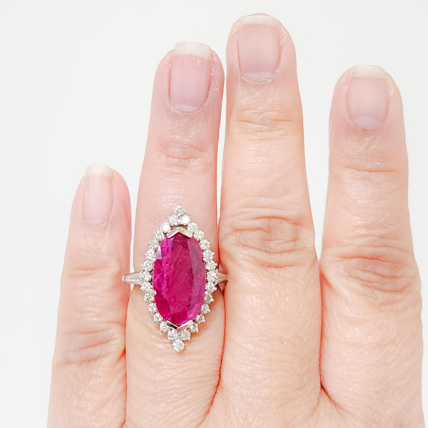 Gorgeous 5.84 carat Mozambique red ruby oval with white diamond rounds and baguettes in size 6.5.  This ring is a perfect accessory for any occasion and comes with a GRS Lab Report.  