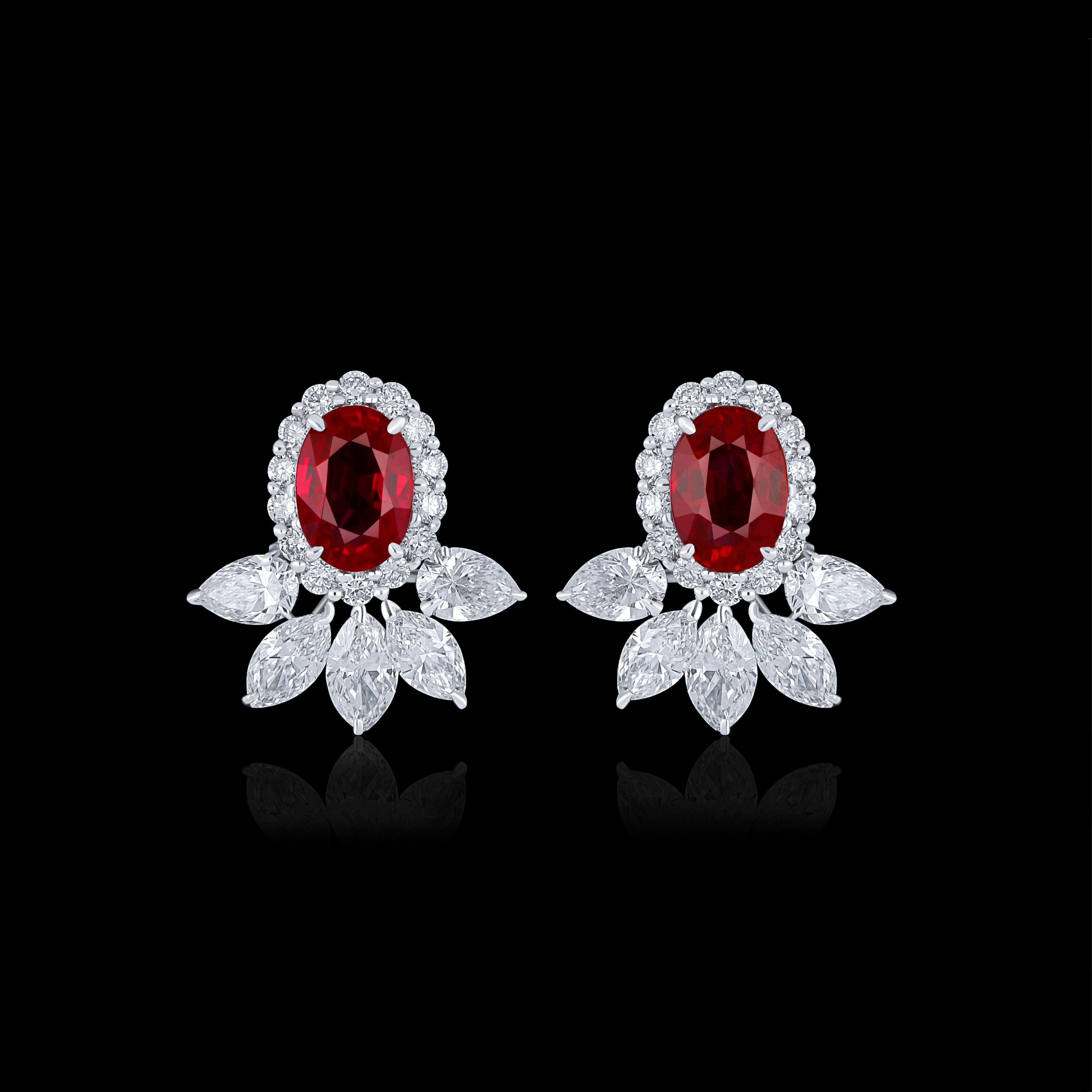 Elegant and exquisitely detailed 18 Karat White Gold Earrings, center set with 1.32Cts .Oval Shape vibrant Red Mozambique Ruby and micro pave set Diamonds, weighing approx. 1.14Cts Beautifully Hand crafted in 18 Karat White Gold.

Stone Detail:
Ruby