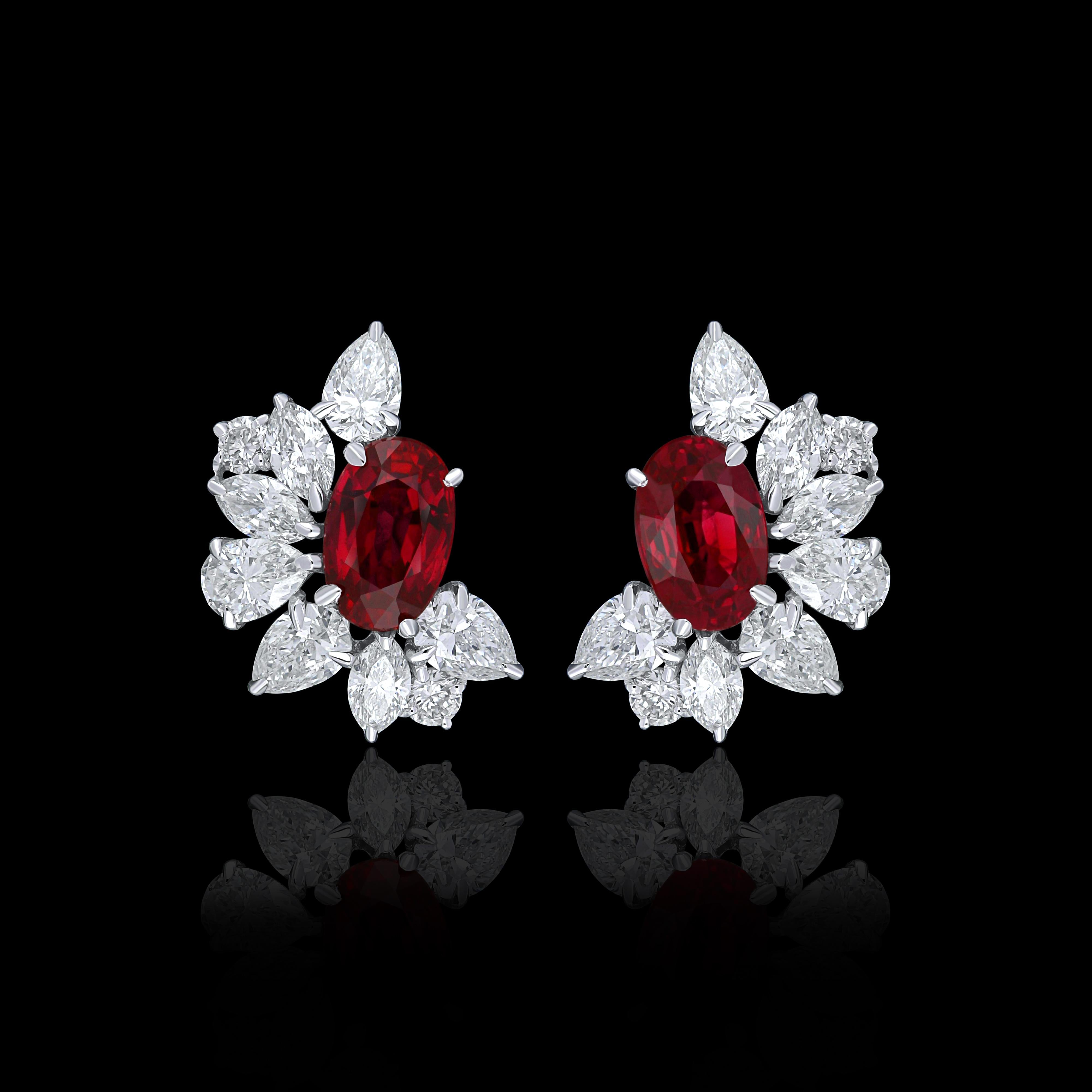Elegant and exquisitely detailed 18 Karat White Gold Earring, center set with 1.28Cts .Oval Shape Mozambique Ruby  and micro pave set Diamonds, weighing approx. 1.30Cts Beautifully Hand crafted in 18 Karat White Gold.

Stone Detail:
Ruby Mozambique: