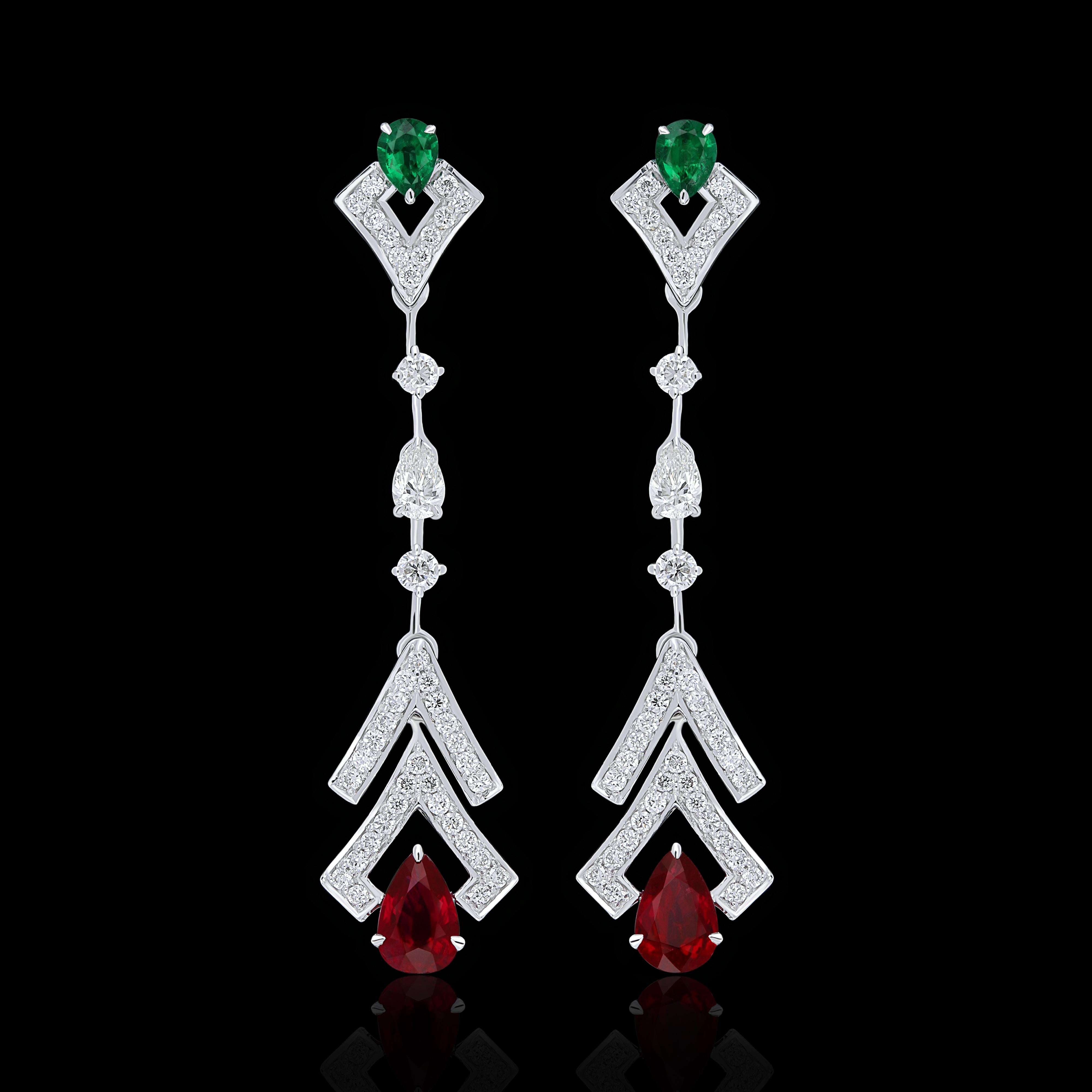 Elegant and exquisitely detailed 18 Karat White Gold Earring, center set with 0.74Cts .Pear Shape Ruby Mozambique with contrast of 0.23 Cts Emerald accented with micro pave set Diamonds, weighing approx. 0.73Cts Beautifully Hand crafted in 18 Karat