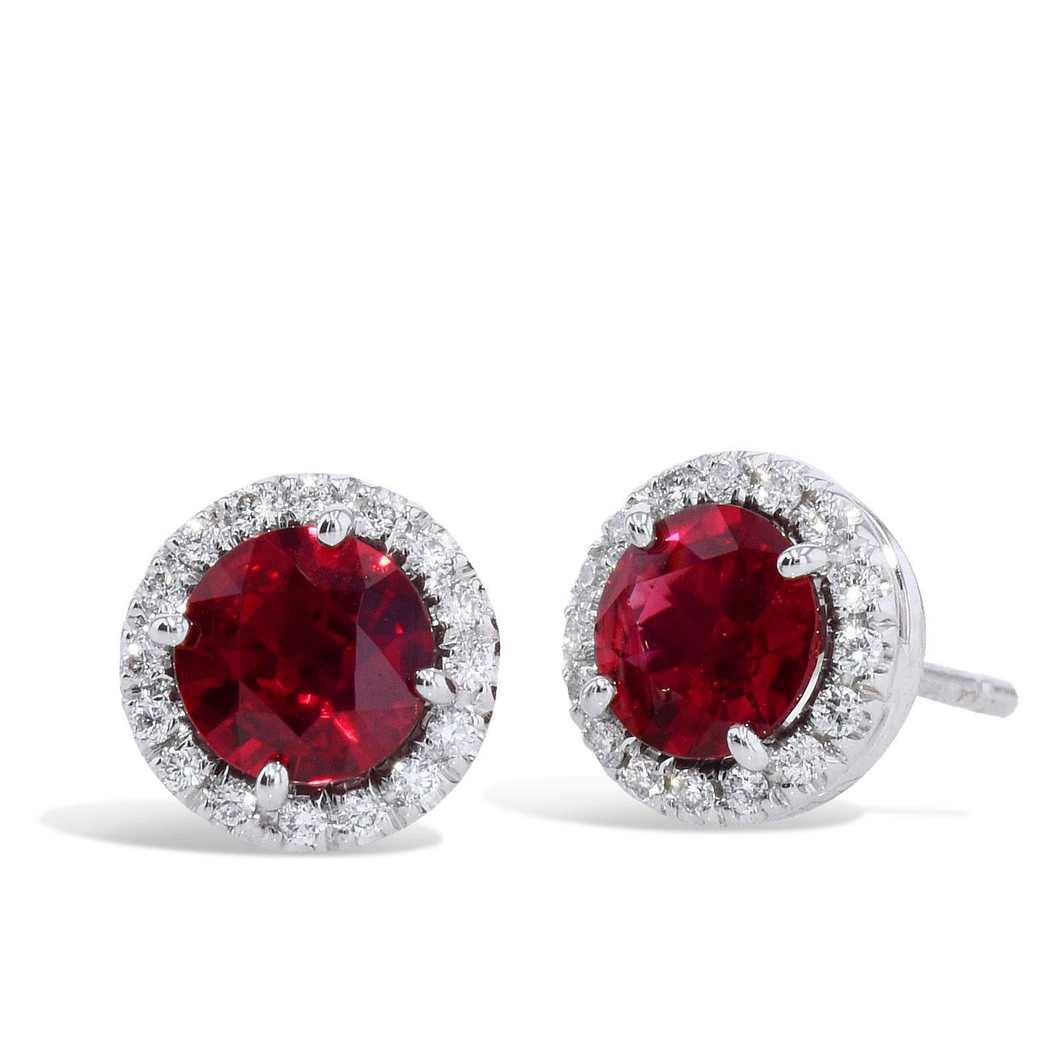 Mozambique Ruby with Diamond Halos Stud Earrings

These lovely handmade 18 karat white gold earrings feature 2 round brilliant cut Mozambique rubies in the center with a total weight of 1.57 carats. 
The rubies are surrounded by 32 round brilliant