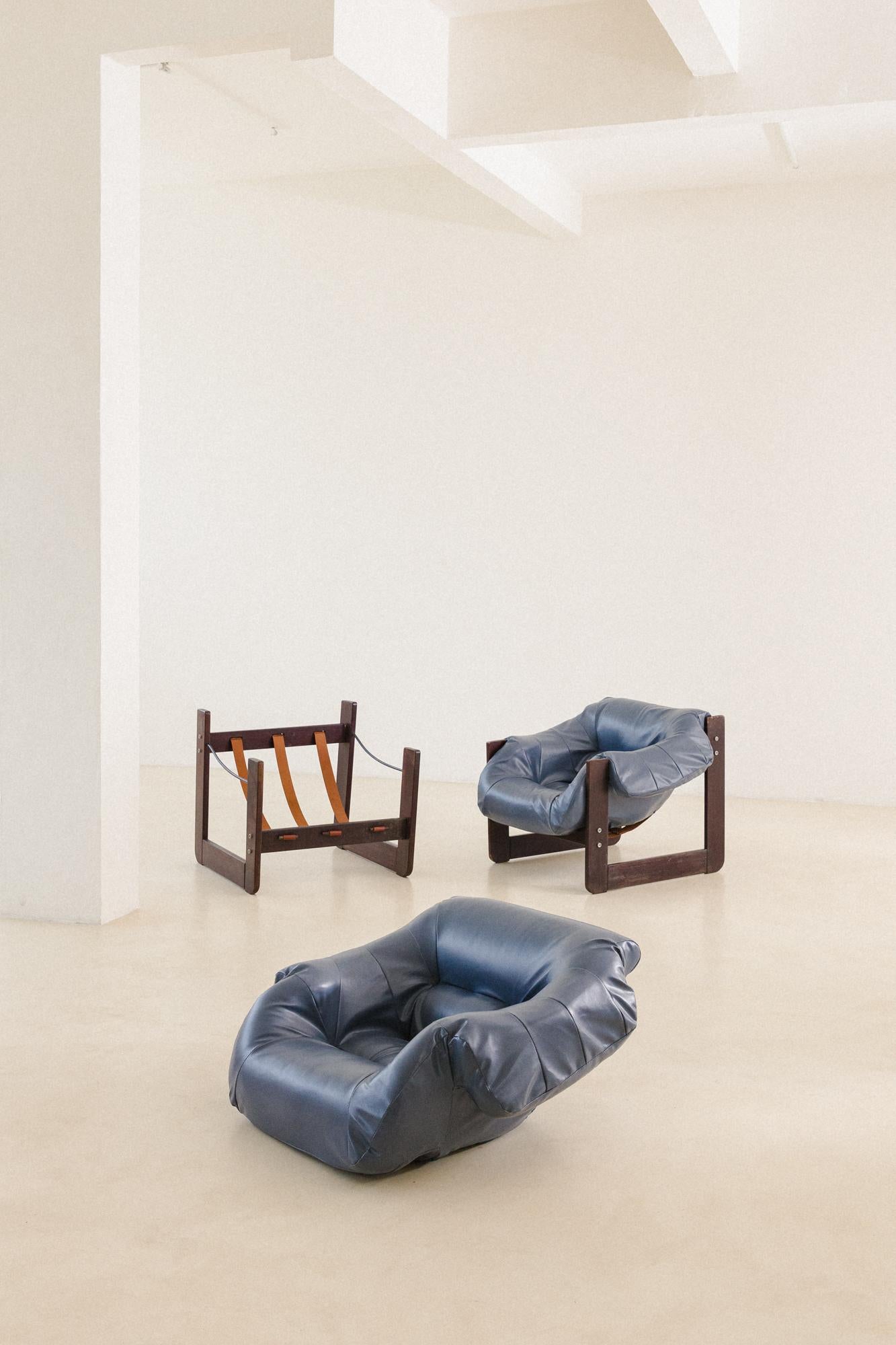 In his designs, Percival Lafer sought ergonomy and comfort. This pair of MP-97 lounge chairs by Percival Lafer comprises a solid wood structure with a single piece of a loose foam seat. Its unique design and construction make this an authentic