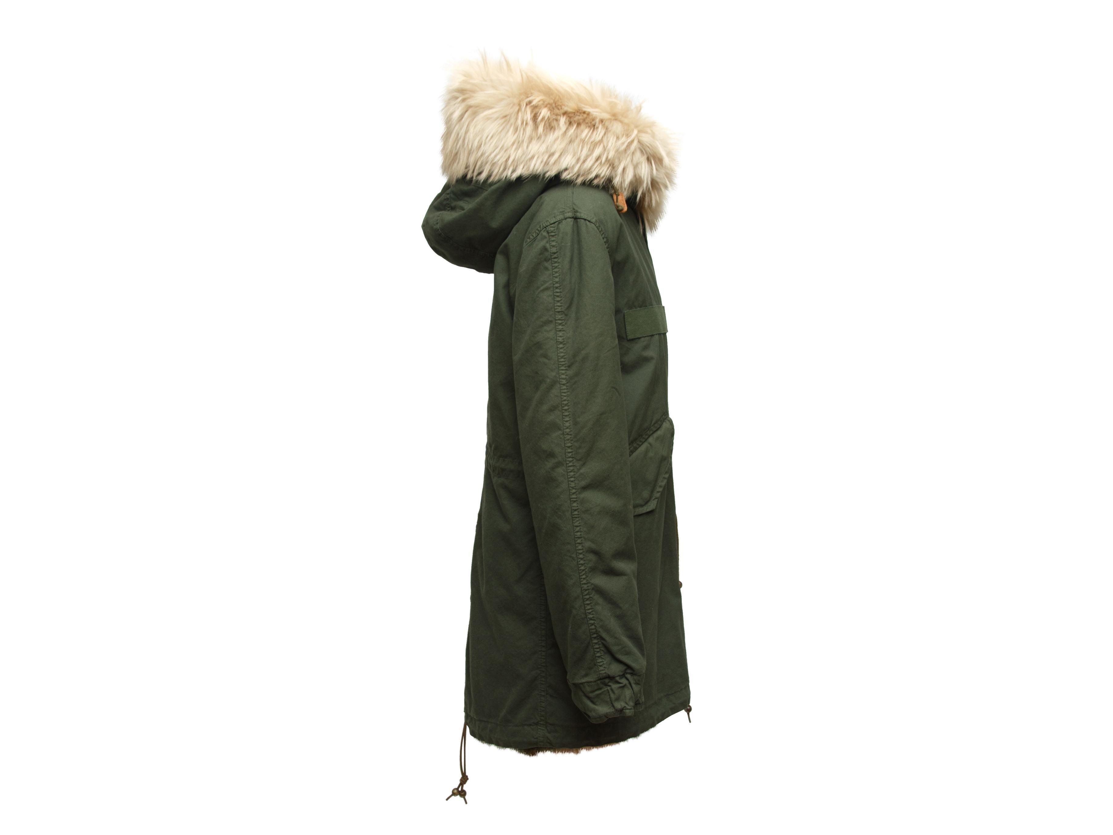 Product details: Olive green hooded coat by Mr and Mrs Italy. Fox fur trim at collar. Dual pockets. Drawstring at waist and hem. Zip closure at front. 41