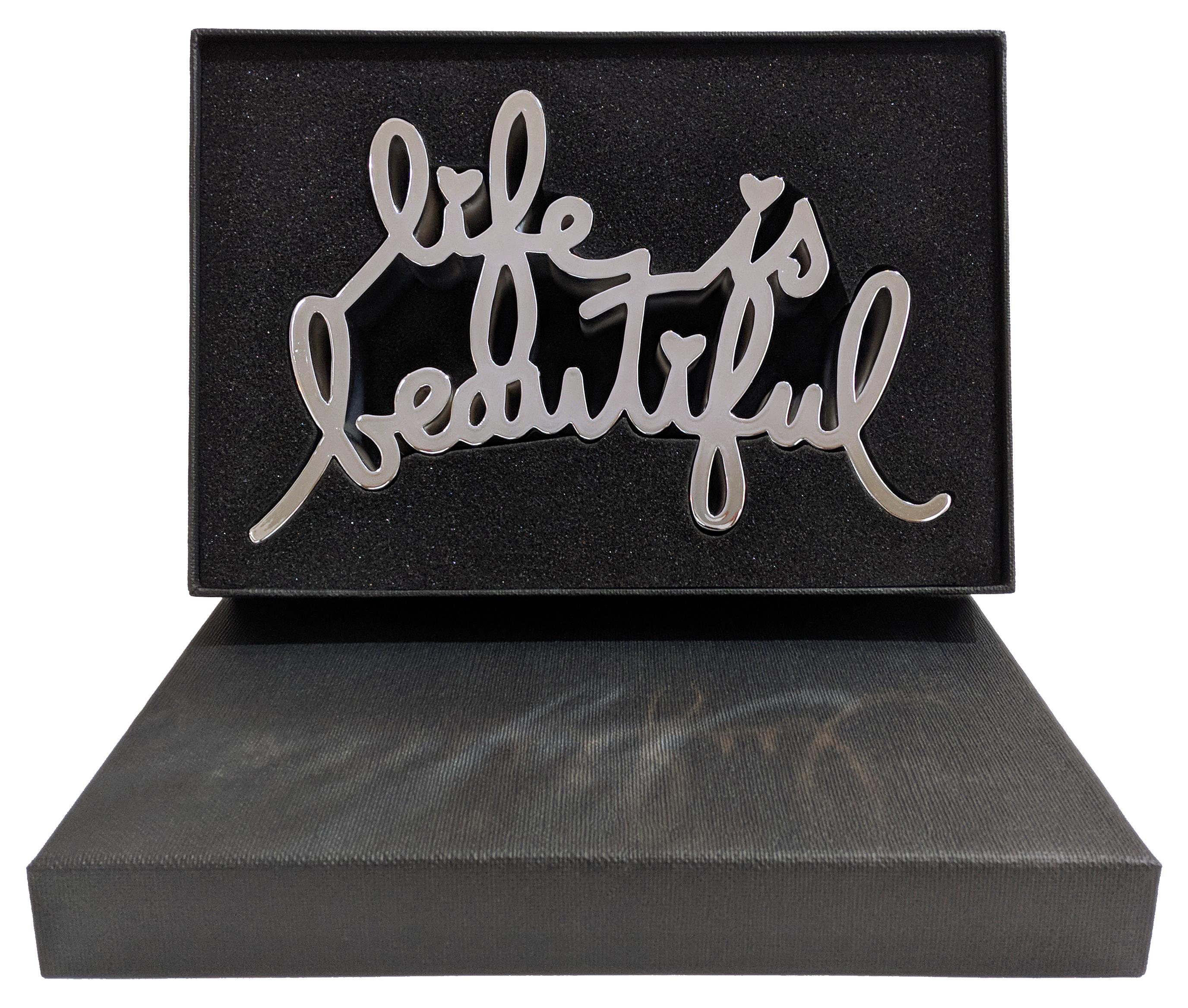 Hand signed, numbered and dated on bottom by the artist. Edition of 100.  The Life is Beautiful sculpture is made from durable cast resin, thermal coated with reflective metallic finish. Includes original box.   Artwork is in excellent condition.