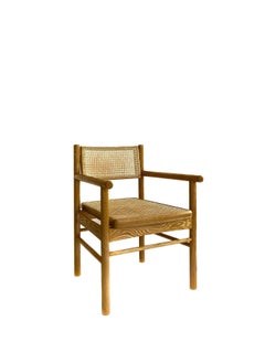 Mr. Cane,  hand canned wicker dining armchair with a self adjustable swivel back