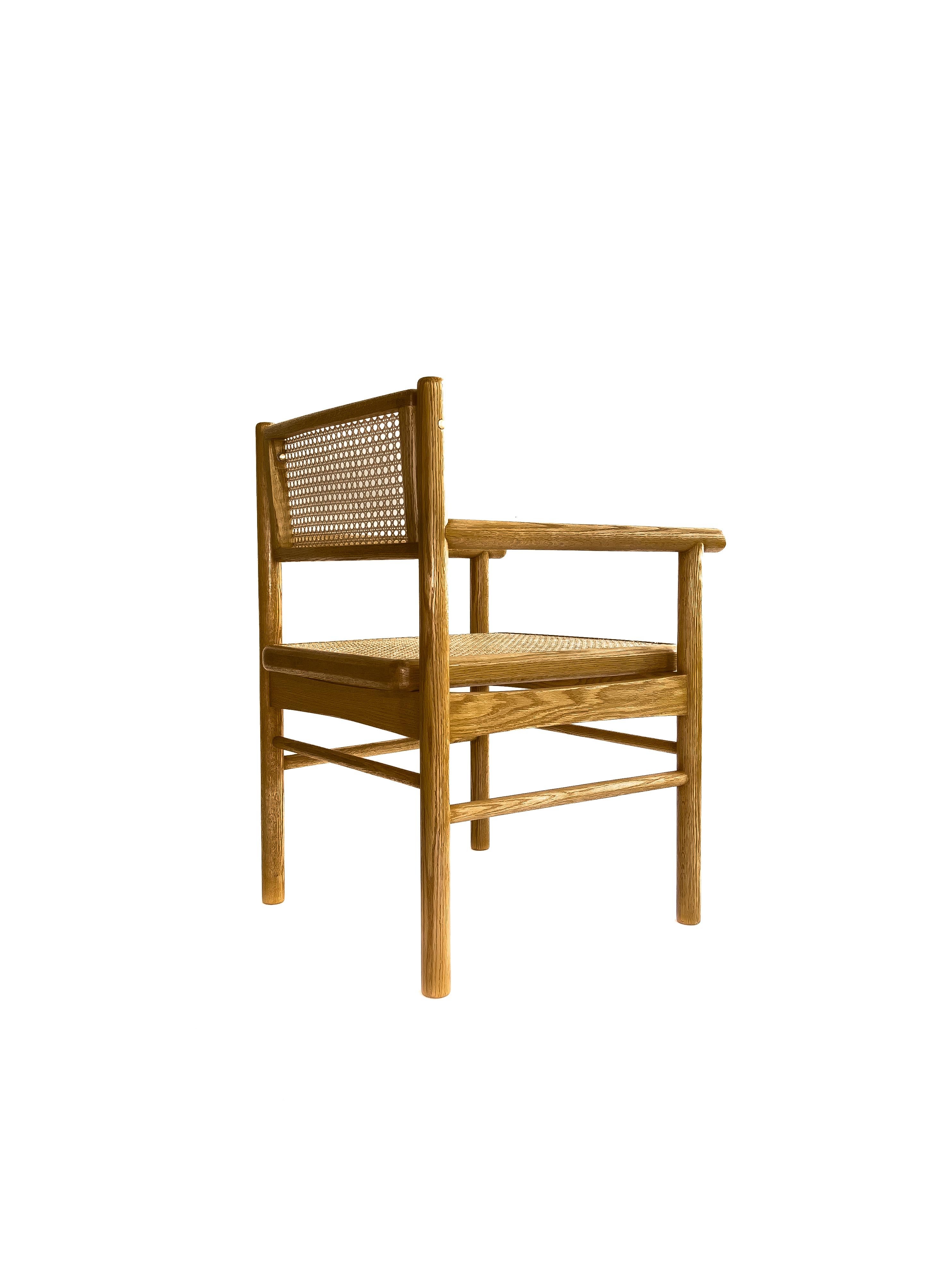 Minimalist Mr. Cane,  hand canned wicker dining armchair with a self adjustable swivel back For Sale