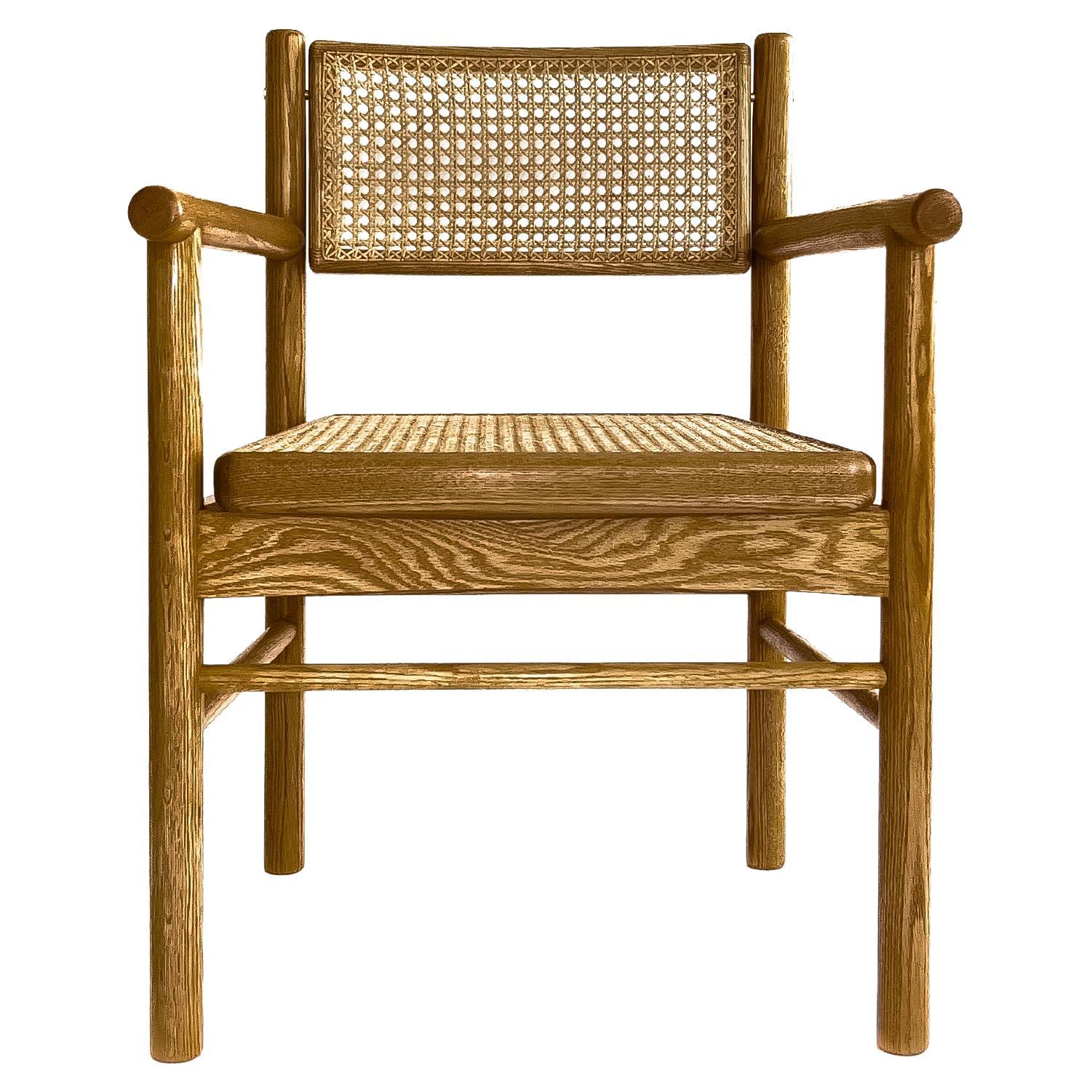 Mr. Cane,  hand canned wicker dining armchair with a self adjustable swivel back For Sale