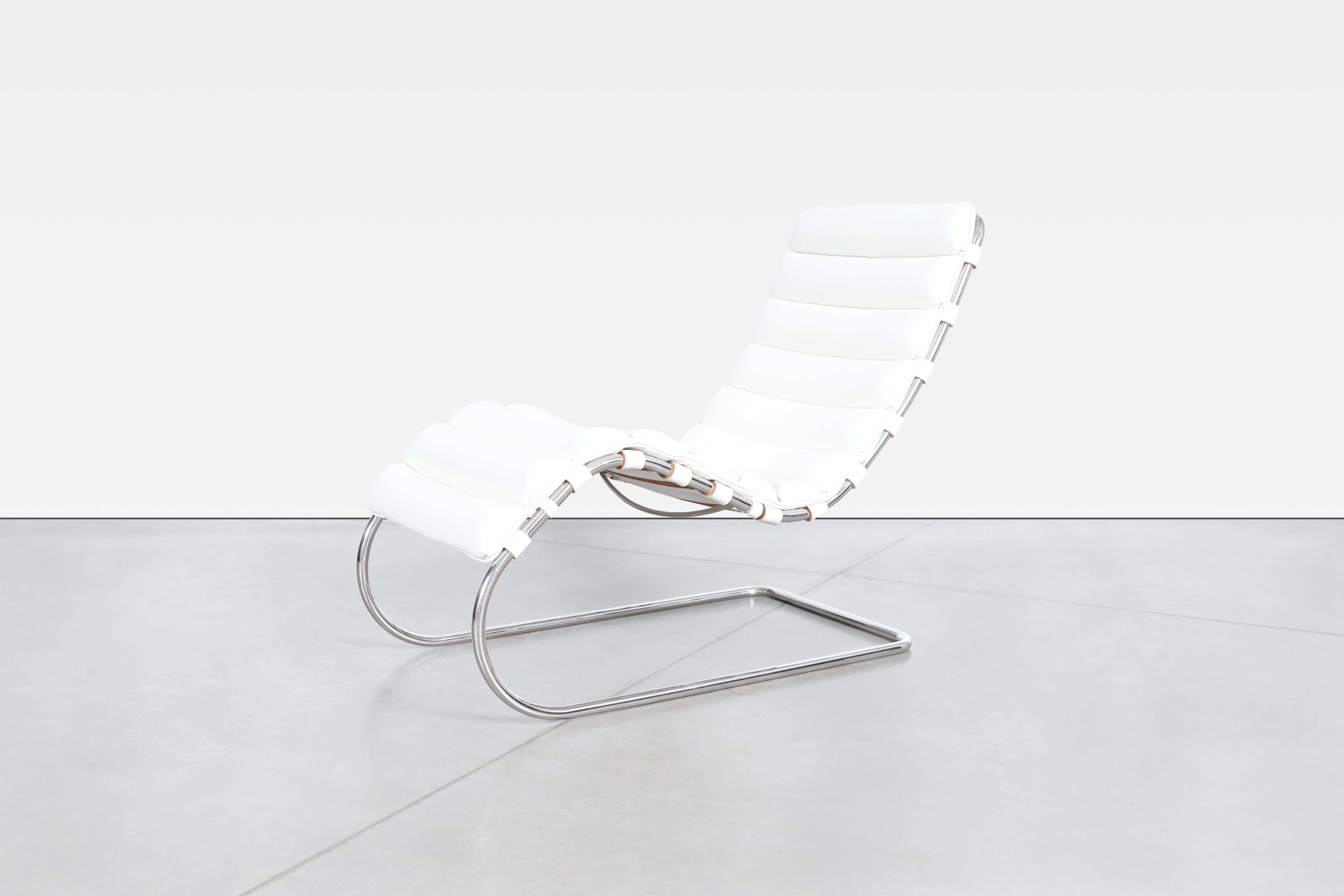 The MR chaise lounge, designed by Mies Van der Rohe, is a sleek and iconic piece of furniture. Its minimalist design features a cantilevered frame made of a steel frame with polished chrome finish, which gives it a light and airy appearance. The