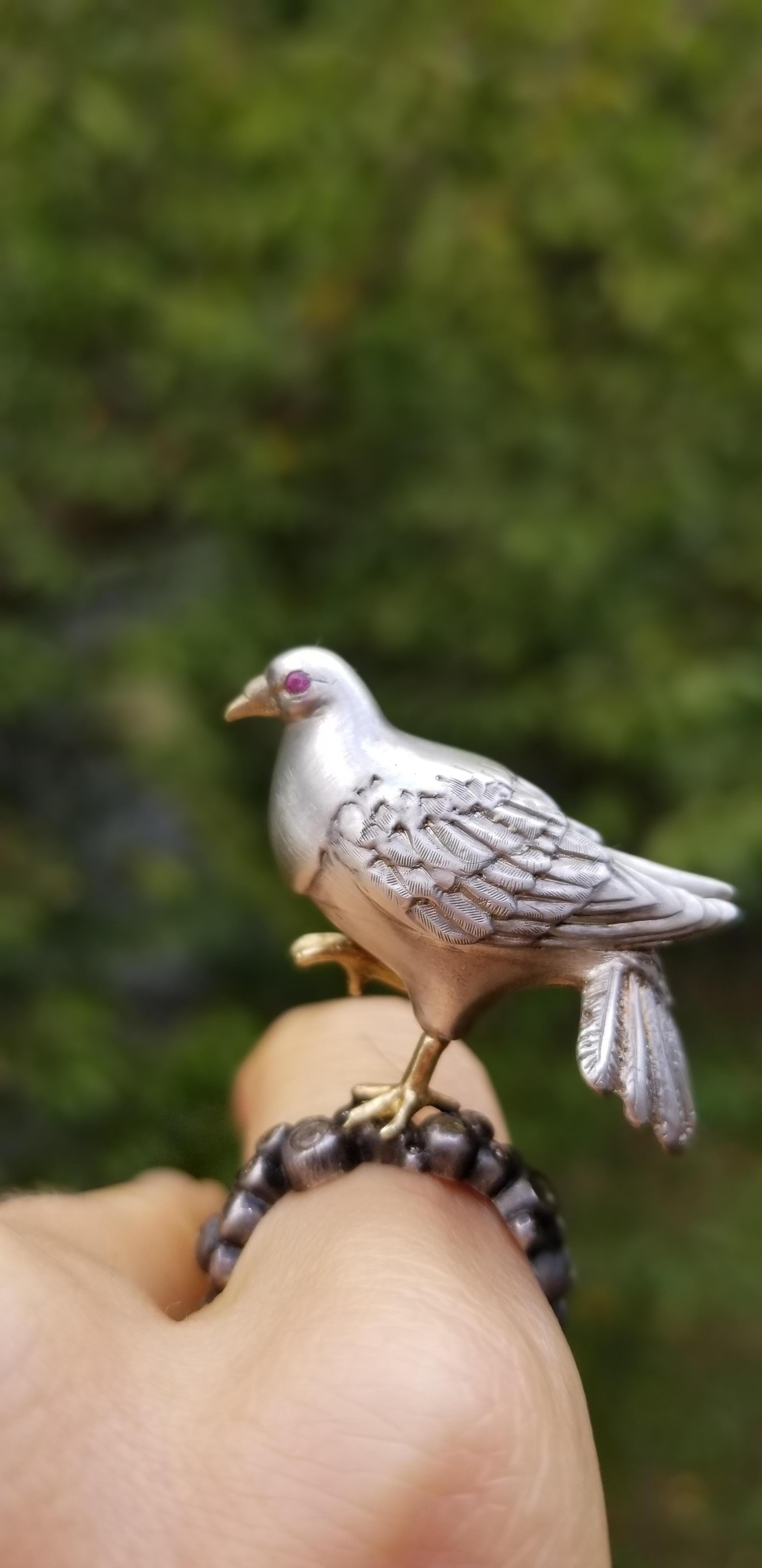 Galant Mr. Dove likes to strut his stuff. 
He parades for his partner atop a band of white diamonds set in oxidized Sterling silver round bezels, which form a band that comfortably encircles the wearer's finger.
He is a one-of-a-kind, originally