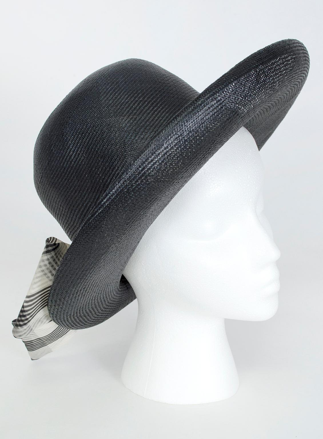 A true transitional piece, this hat can take you from season to season thanks to its tight weave and dark color. The fixed scarf adds the bit of French flair for which the milliner was beloved.

Straw basketweave sun hat with rolled brim trimmed in