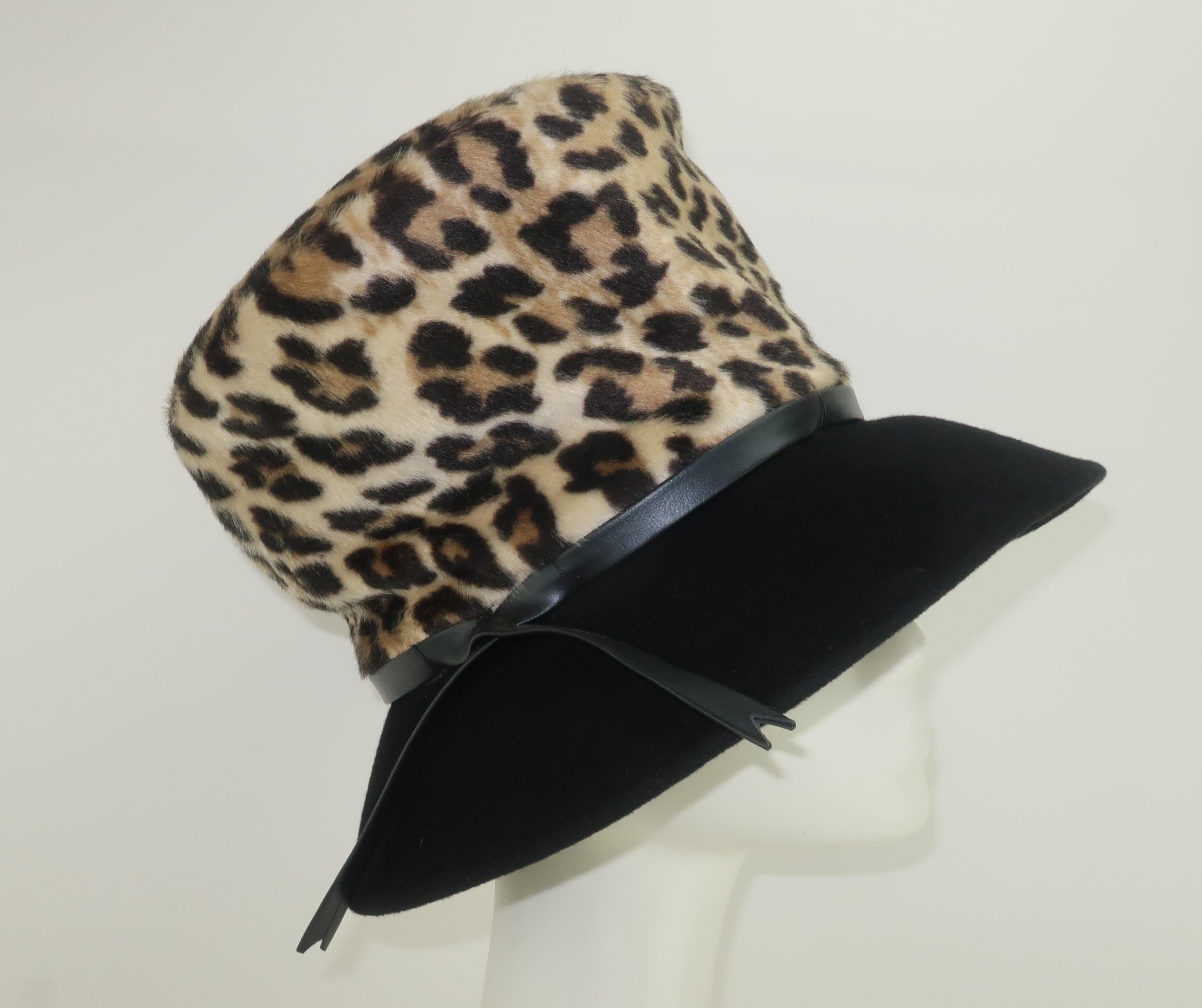Purrrfect!  Mr. John Classic faux leopard mohair hat with a great combination of a mad hatter silhouette and a period perfect 1960’s ‘floppy’ style.  The hat is constructed in a faux fur with wool felt brim and a leatherette crisscross band.  The