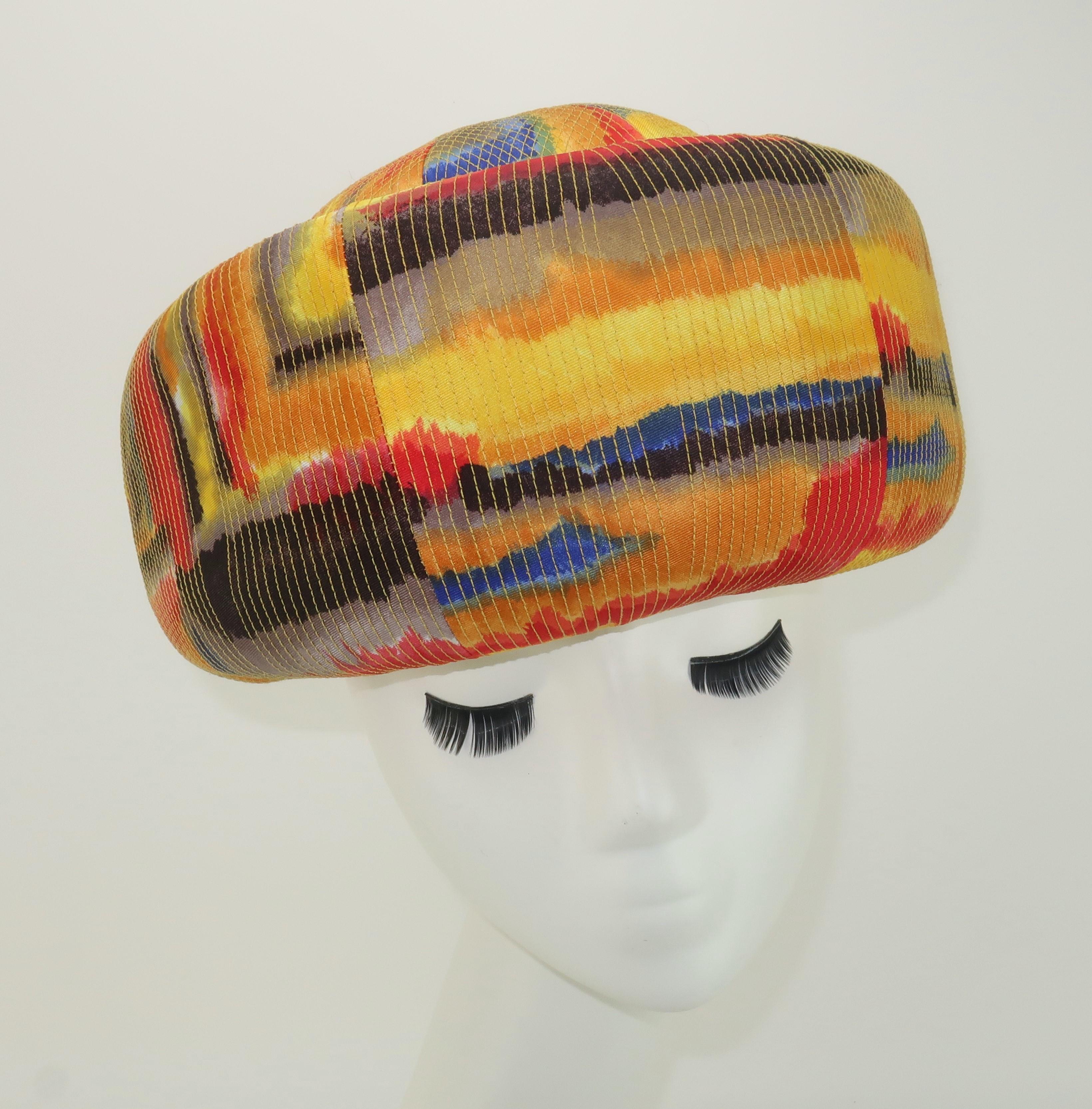 1960's Mr. John hat with an exaggerated pillbox silhouette in a colorful silk faille fabric with intricate stitching and golden yellow grosgrain band.  The mod print is reminiscent of watercolors with blended lines of yellow, golden yellow, blue,