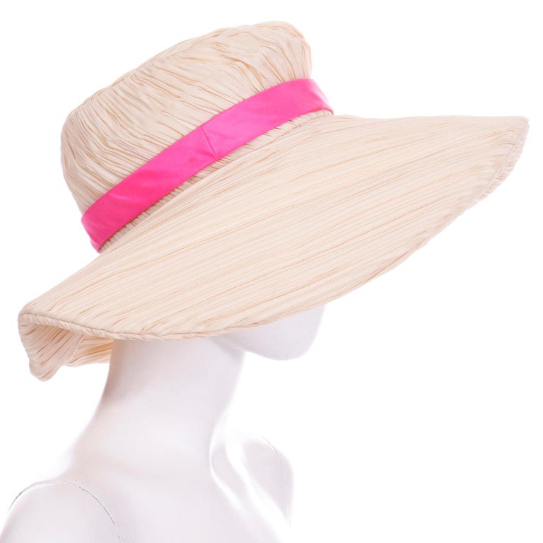 We love Mr. John vintage hats and this one is so unique! This late 1960's cream fully pleated hat has a wide floppy brim and a pretty hot pink silk band. The hat is easy to wear and would be fun to wear with a summer maxi dress or swimsuit! 
INNER