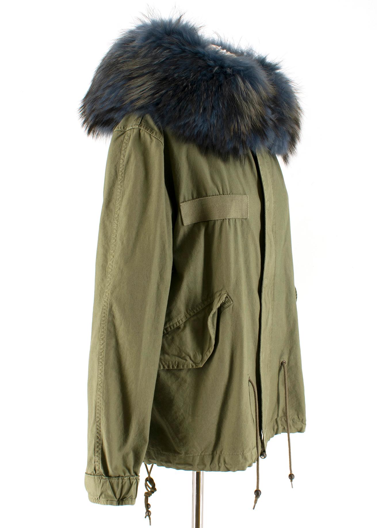 Mr & Mrs Italy Green Parka Coat with Blue Fur Hood

Cotton parka coat with soft navy blue fur hood,
Long sleeves, 
Front centre zip fastening,
Features snap button,
Button up cuffs,
Fur trim hood is removable, 
Front flap