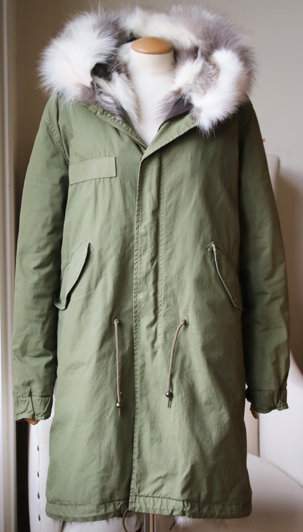 This version has been made by Italian artisans from hard-wearing cotton-canvas and lined in plush white and grey fox-fur. The zip is backed with leather so it won't pull the soft fibers. Army-green cotton-canvas, white and grey fox-fur.  Concealed