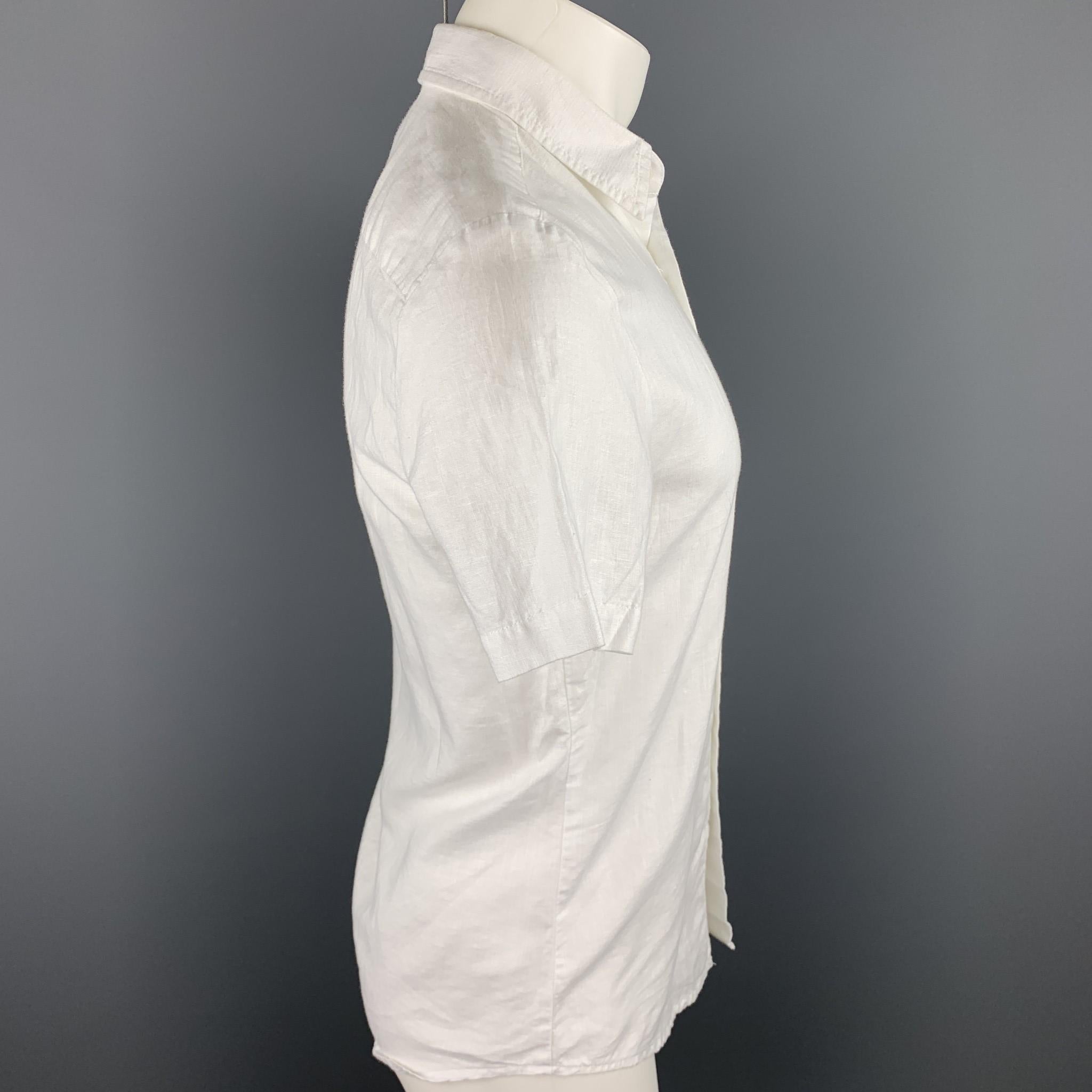 MR. TURK short sleeve shirt comes in a white linen / cotton featuring a button up style, patch pocket, and a spread collar. 

Excellent Pre-Owned Condition.
Marked: XS

Measurements:

Shoulder: 16.5 in. 
Chest: 36 in. 
Sleeve: 8.5 in. 
Length: 28