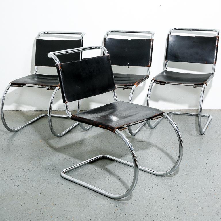 Vintage set of 4 MR10 dining chairs by Mies van der Rohe. Chrome cantilevered frames with black leather sling upholstery. Original leather shows a desirable level of patina and have been recently conditioned. Signed with 'Made in Italy'. Measure: