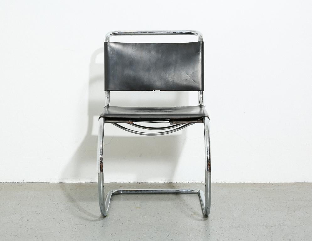 Vintage 'MR10' side chair designed by Bauhaus architect Mies van der Rohe. Black slung leather upholstery with tubular chrome frame. Unsigned, but likely a Stendig production.