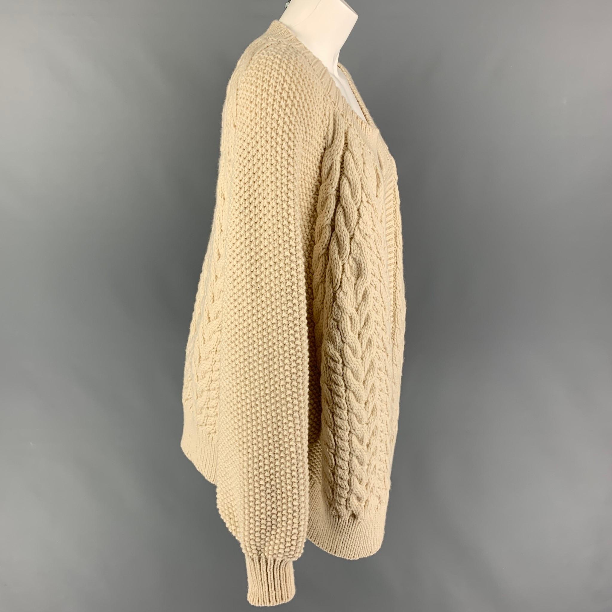 MR. MITTEN cardigan comes in a beige knitted wool featuring a oversized fit, collarless, and a open front. 

Very Good Pre-Owned Condition. Light mark at front. As-Is.
Marked: One Size

Measurements:

Shoulder: 18 in.
Bust: 52 in.
Sleeve: 30