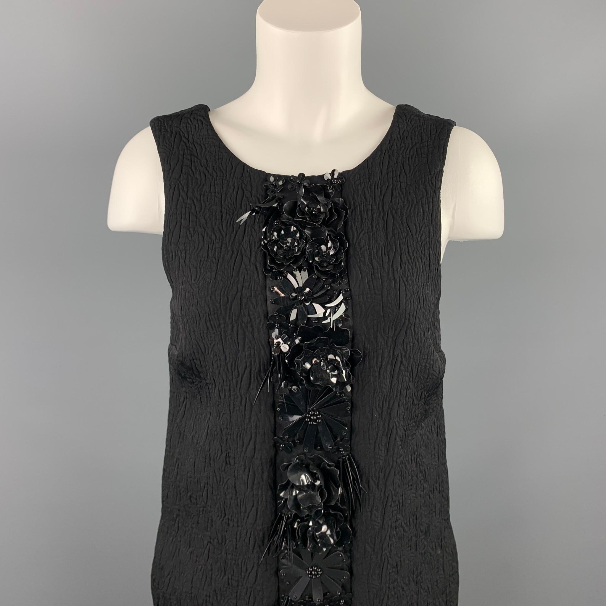 MSGM dress comes in a black jacquard viscose blend with front embellished designs featuring a shift style, slit pockets, and a back zip up closure. Made in Italy.

Very Good Pre-Owned Condition.
Marked: 40

Measurements:

Bust: 32 in. 
Waist: 34 in.