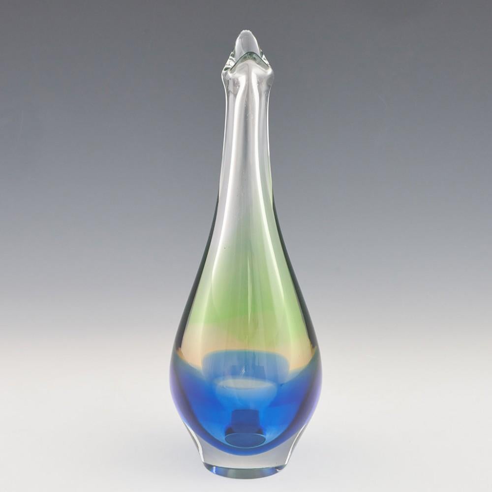 Heading : Vladimir Mika vase designed for either Moser or Mstisov
Date : Designed 1964
Origin : Czechoslovakia
Bowl Features : Lime green, ink blue, and clear glass with tapering neck and asymmetrical rim
Type : Lead
Size : 28.5cm height, 10cm