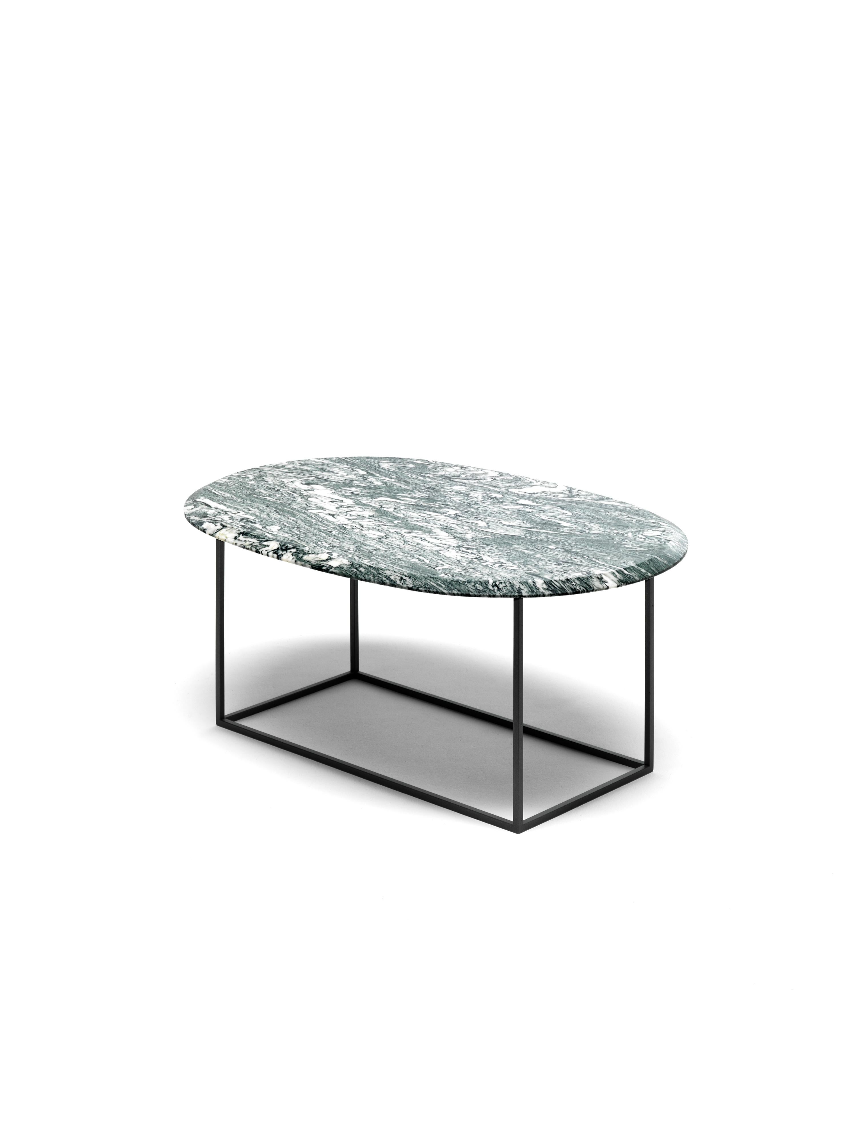 Our MT coffee table is at once simple and rich. The base is made with a very thin squared metal tubing which results in physically and visually light and clean geometric structure. The oval top is thick solid marble made visually lighter by a