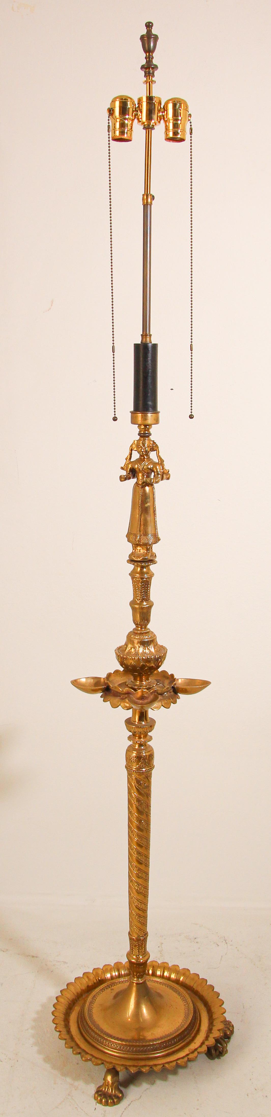 Mughal Raj Hindu Indian Brass Temple Oil Lamp turned into a floor lamp.
Rewired in the US.
Polished brass handcrafted in India.
Brass oil lamp to top brass head is 41