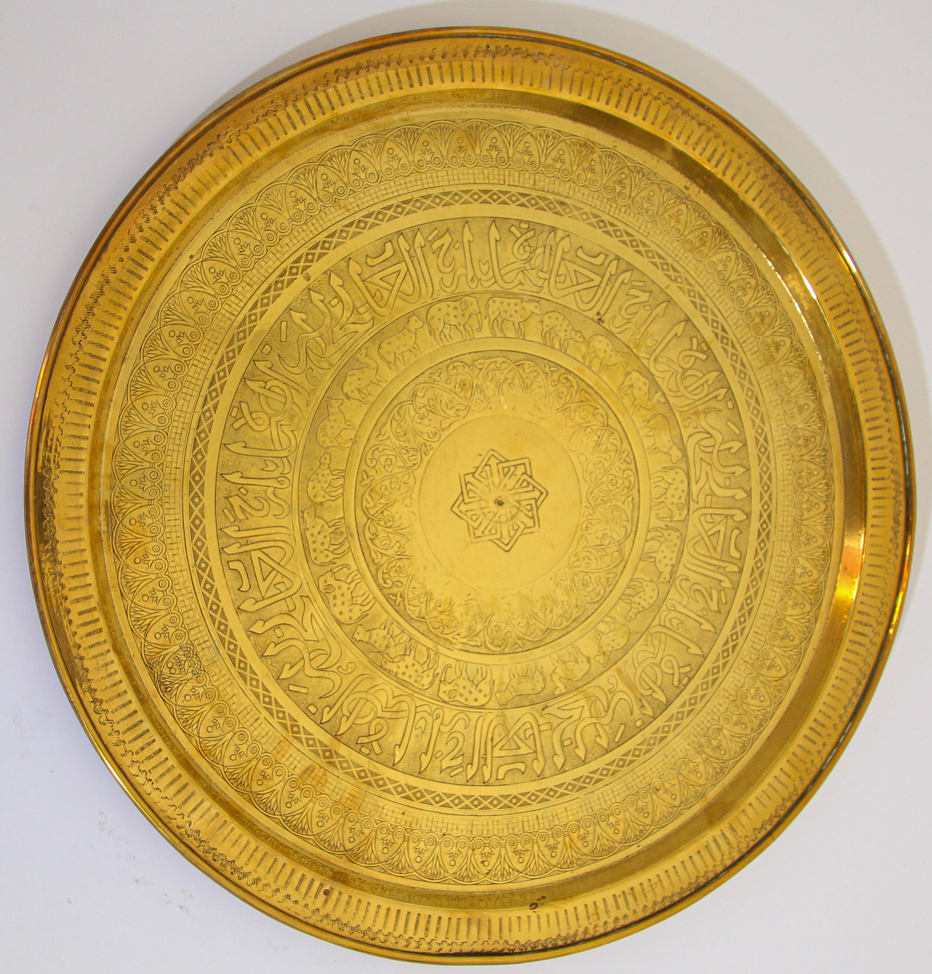 Large handcrafted decorative Indian Mughal Moorish brass tray.
Embossed and hammered with floral and mystique animal scenes with Arabic script etched.
Large decorative hanging platter with pie crust edges, religious design with sacred cows all