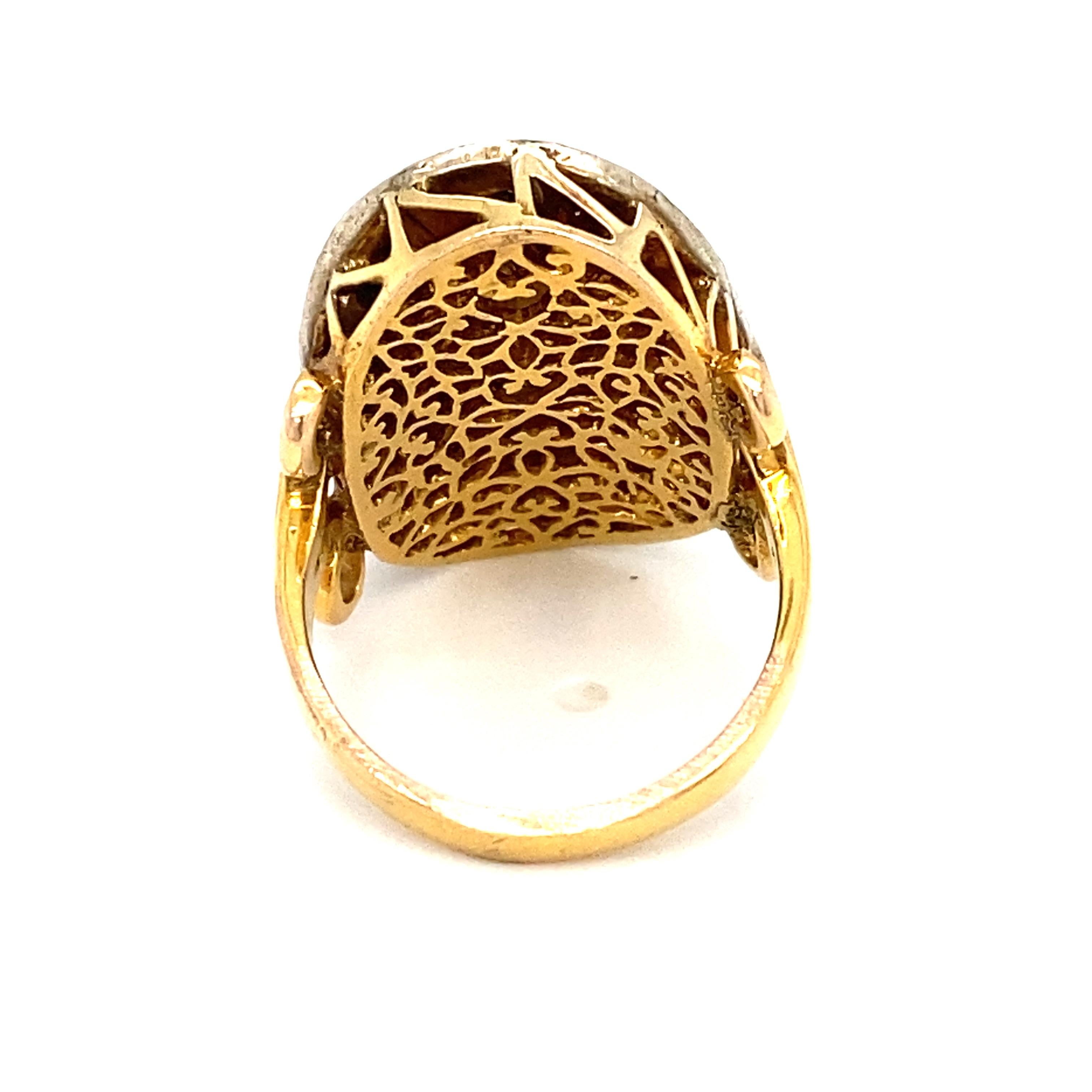 Item Details: This ring is a reproduction of the jewelry popular in the Mughal period of India. It features a foil-backed oblong rose cut diamond in the center with a halo of accent diamonds.

Circa: 2000s
Metal Type: 18k gold
Weight: 7.8g
Size: US