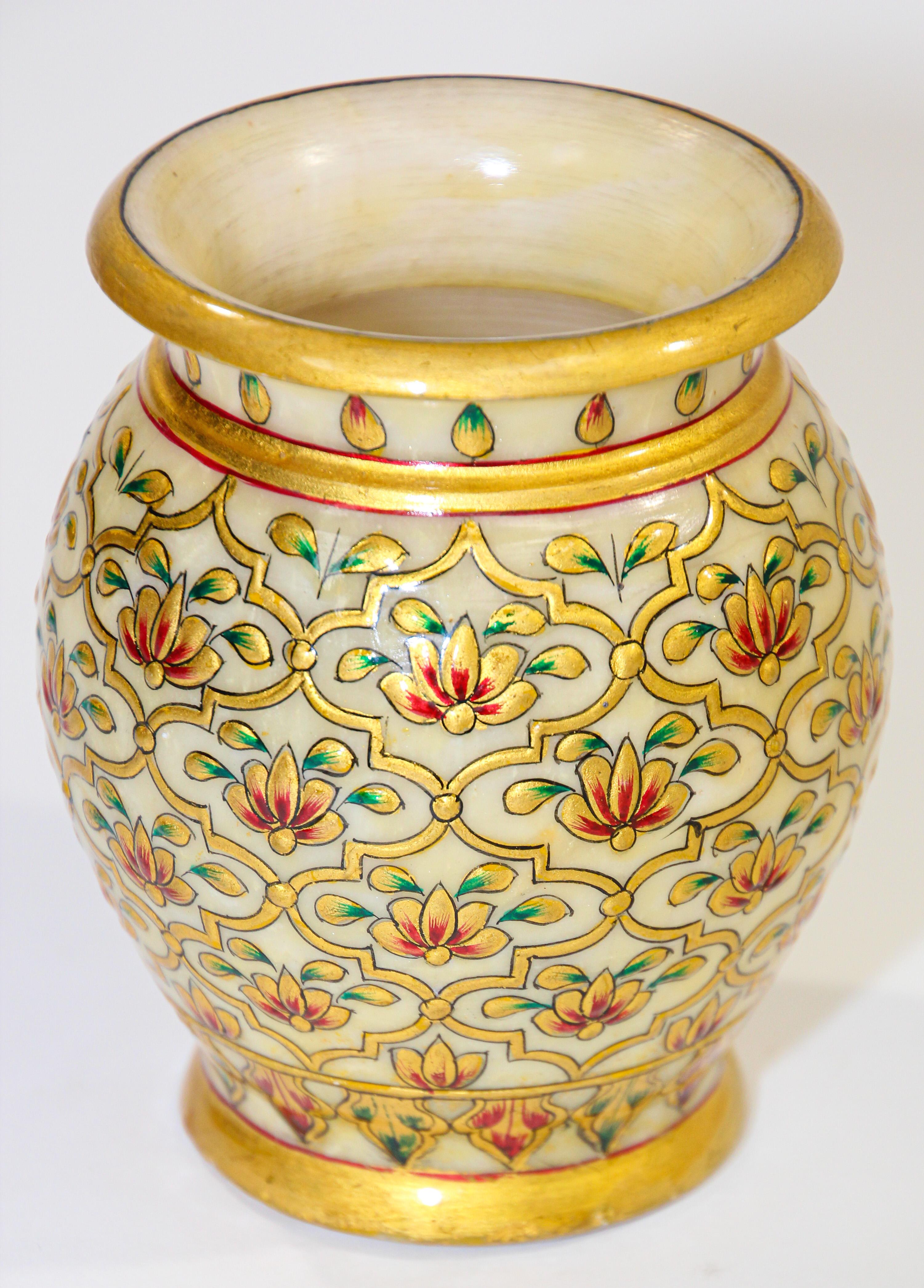 Indian Mughal style Makrana marble vase hand carved and hand painted with gilt and polychrome floral design.
Beautiful Makrana marble vase overlaid and hand painted throughout in Moorish geometric design and Indian Mughal Raj arabesque.
This stylish