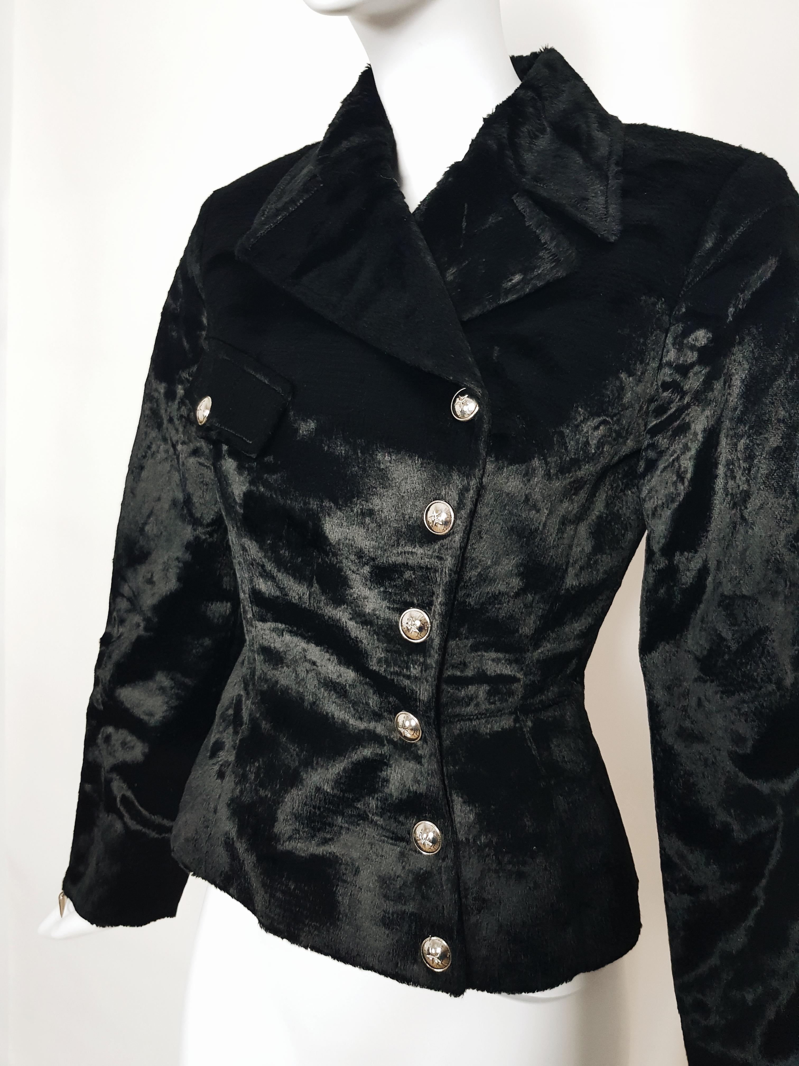 Made of soft black faux fur fabric, this biker jacker has the emblematic sculpted Mugler’s shape. 

-Double breasted biker cut
-Closed by six silver snap buttons embellished with a star
-One breast fake pocket
-Long sleeves with silver decorative