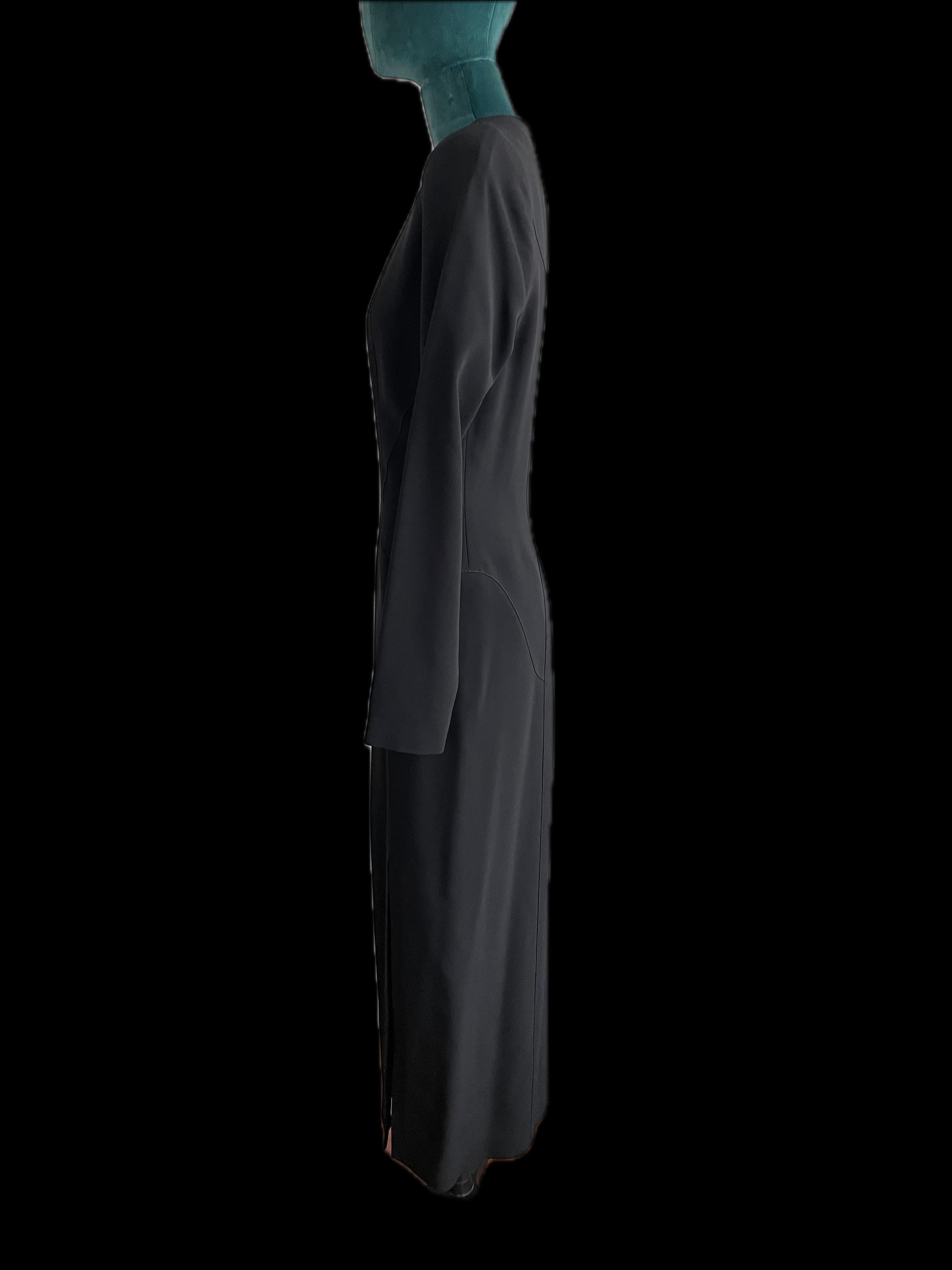 
Introducing the epitome of modern sophistication: the Mugler Black Long Sleeve Gown. Crafted with meticulous attention to detail and designed to accentuate the body's natural curves, this exquisite piece exudes timeless elegance and contemporary