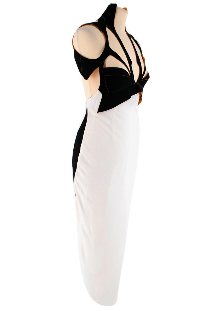 Mugler Black and White Cutout Midi Dress 


This Black & White Midi dress by Mugler features an asymmetrical technical cut-out along the neckline padded by a bright orange interior.
The silhouette is fitted and features a draped rear vent, a