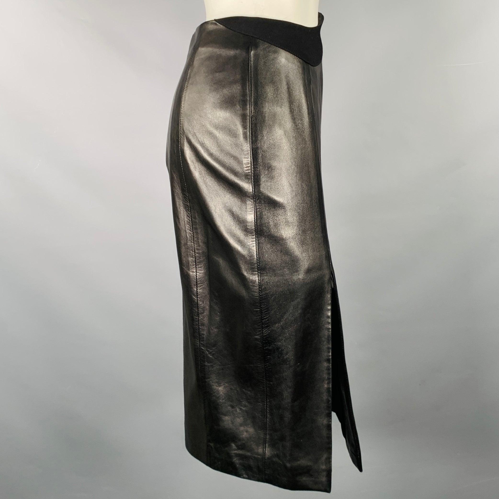 MUGLER skirt
in a black lambskin leather fabric featuring a pencil style with side slit, wavy polyester blend waistband detail, and back zipper closure. Made in France.Excellent Pre-Owned Condition. 

Marked:   36 

Measurements: 
  Waist: 26 inches