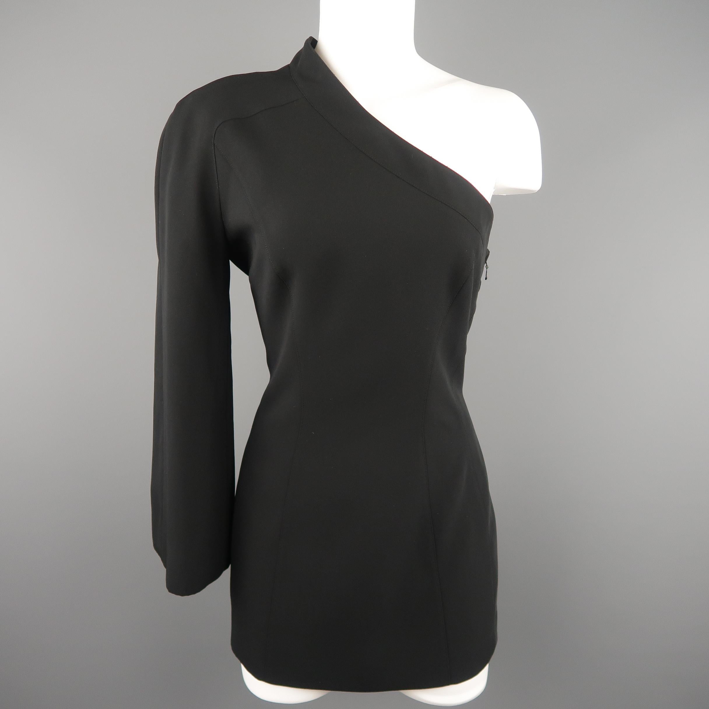 MUGLER by Thierry Mugler Circa 2000 mini dress comes in black twill with a V neckline, long sleeves, fitted silhouette, side zip and half snap off sleeve panel for an asymmetrical one shoulder look. Made in Hungary.
 
Excellent Pre-Owned Condition.